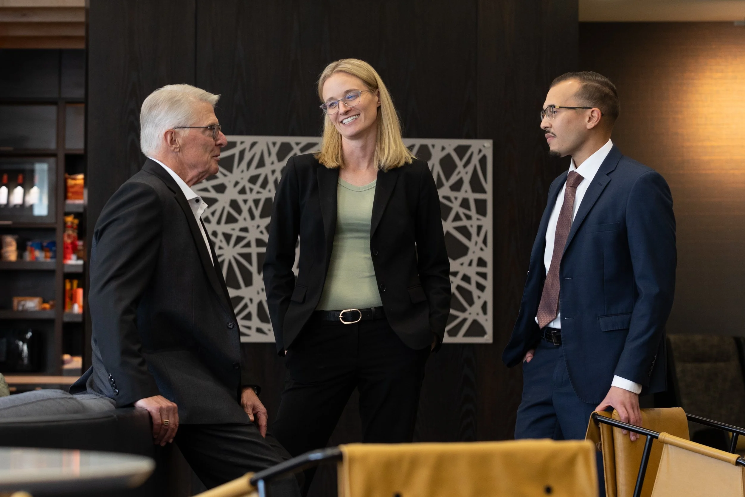 business professionals casually talking in a hotel lobby.