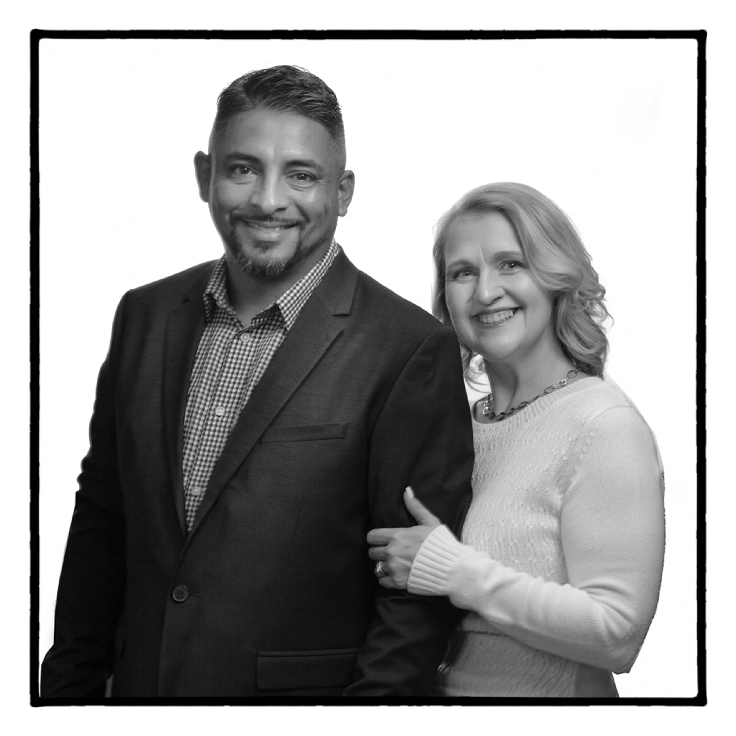 black and white portrait of couple in front of white background