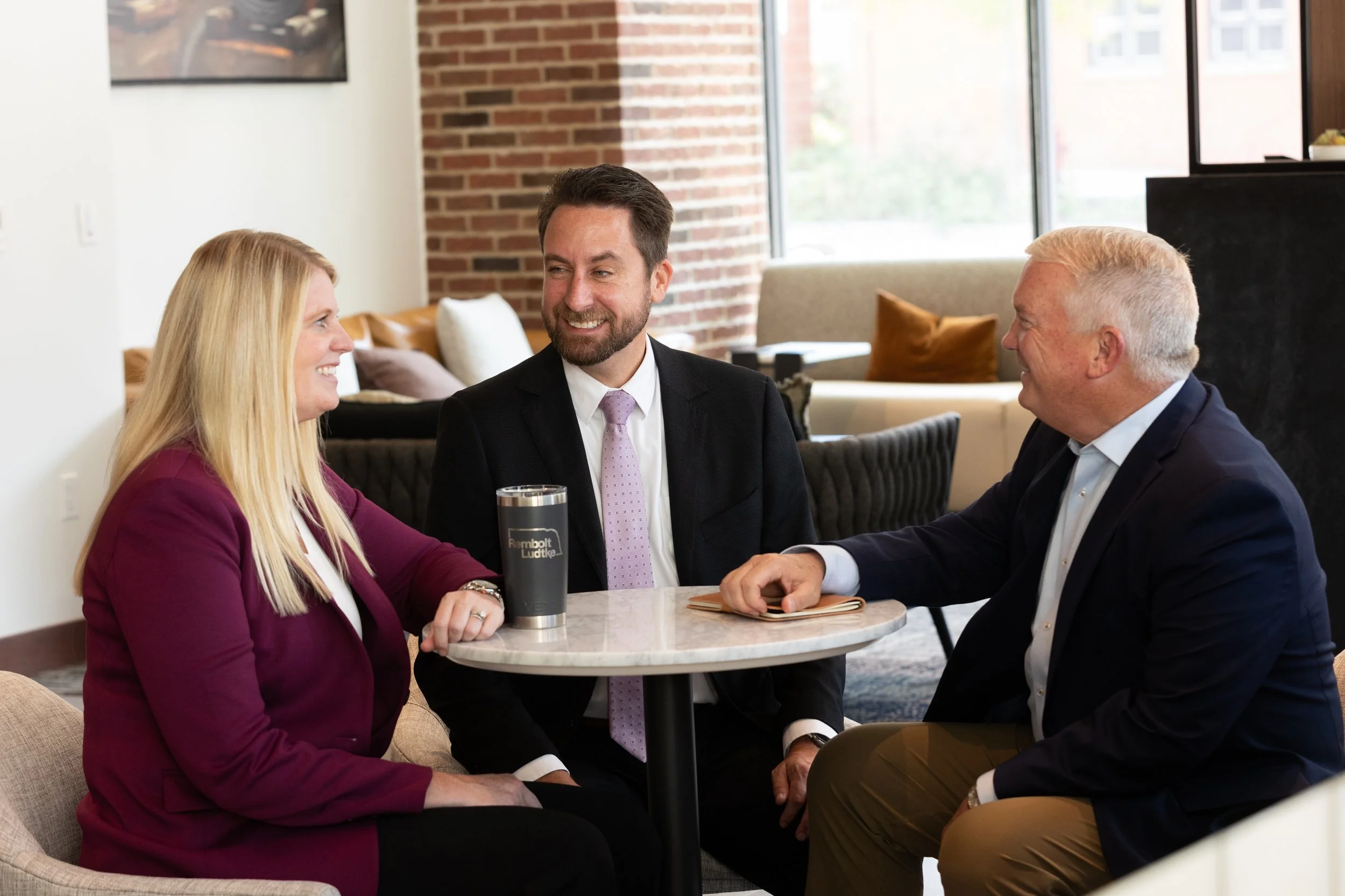 business professionals having a casual conversation at table.