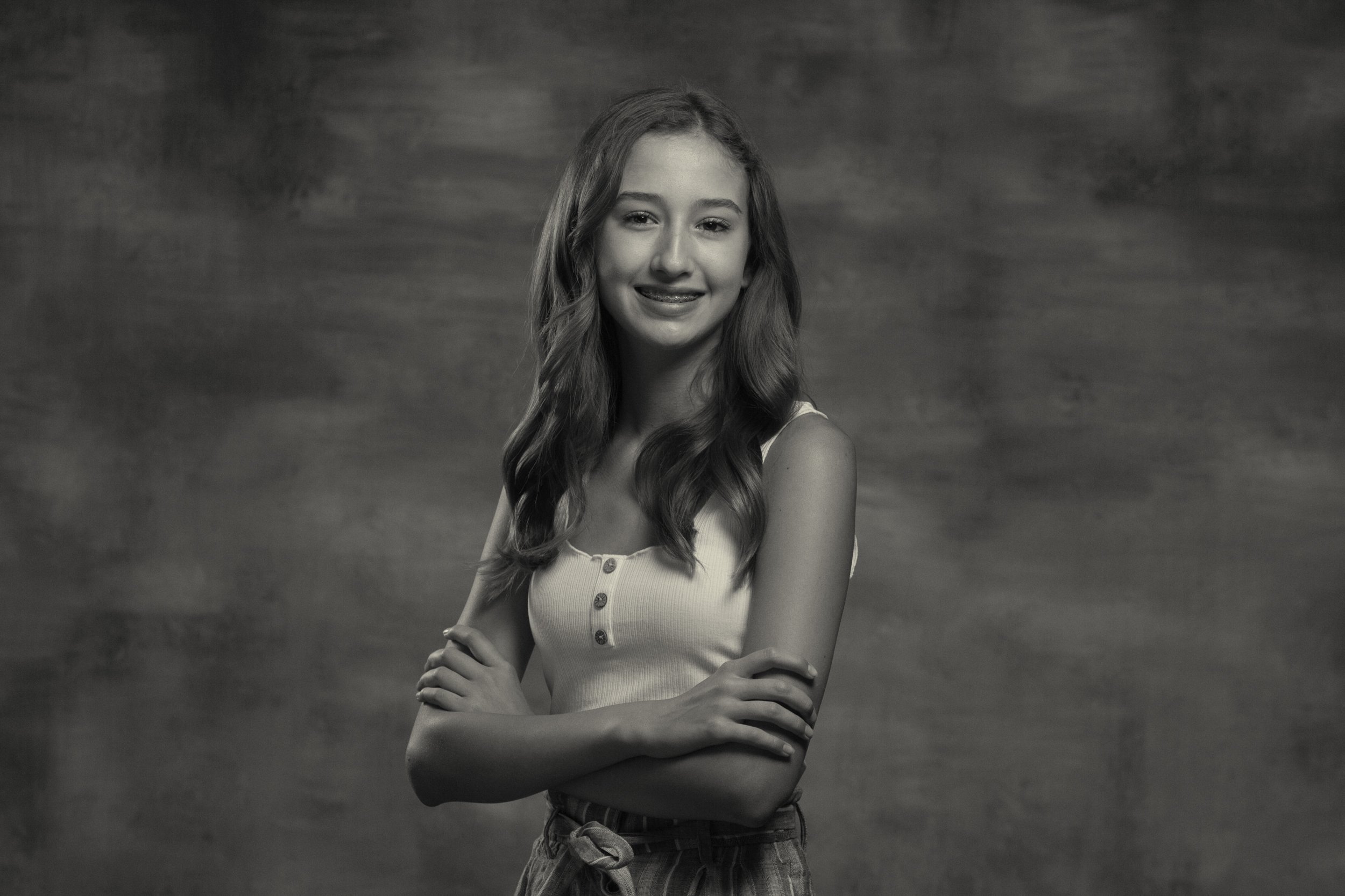 black and white portrait of tween crossing her arms