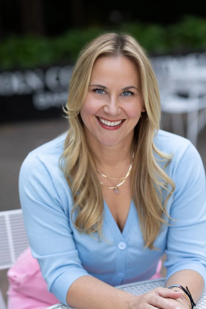 outdoor professional women portrait in pink pants and blue blouse.