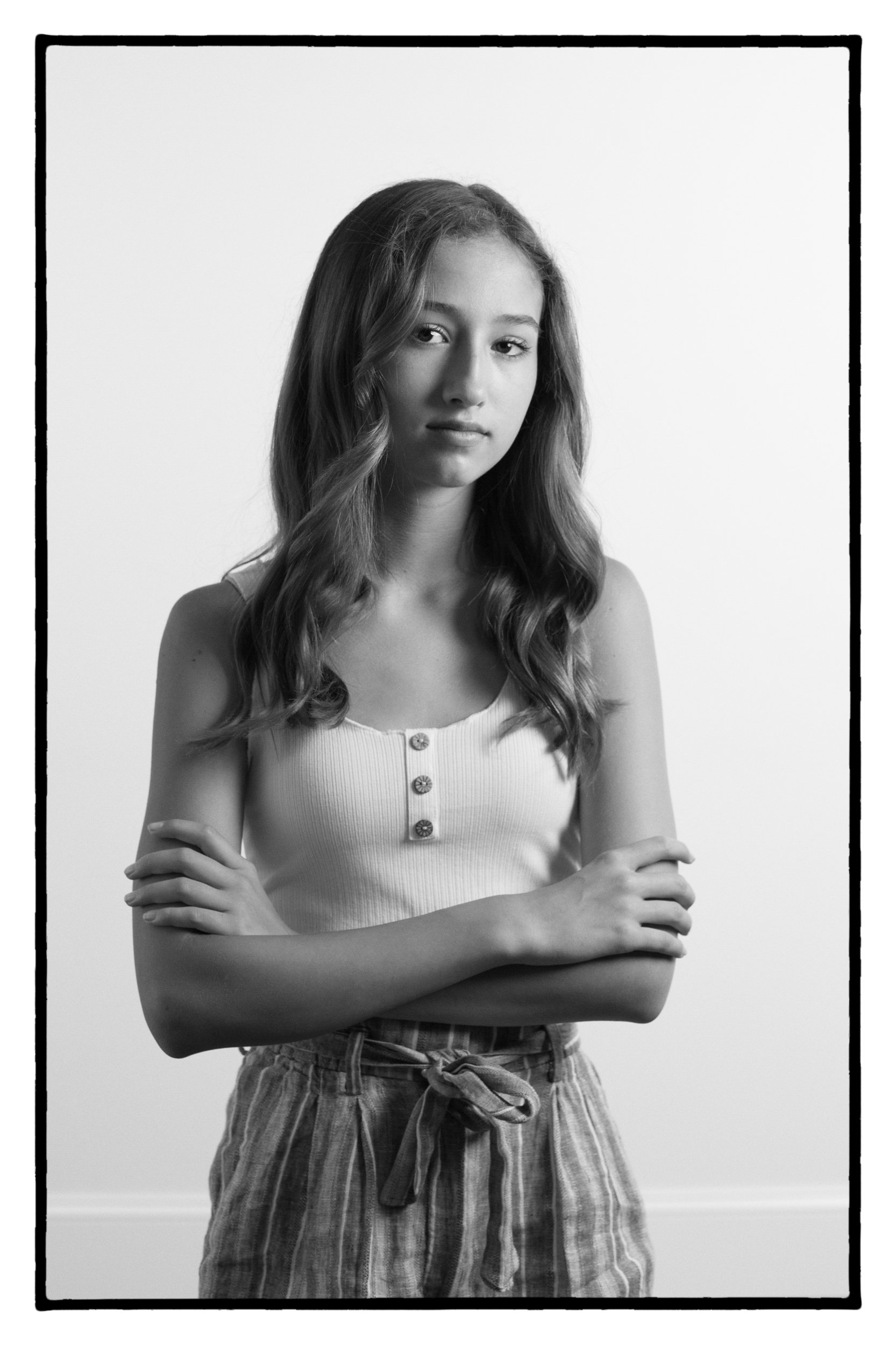 black and white portrait of tween crossing her arms