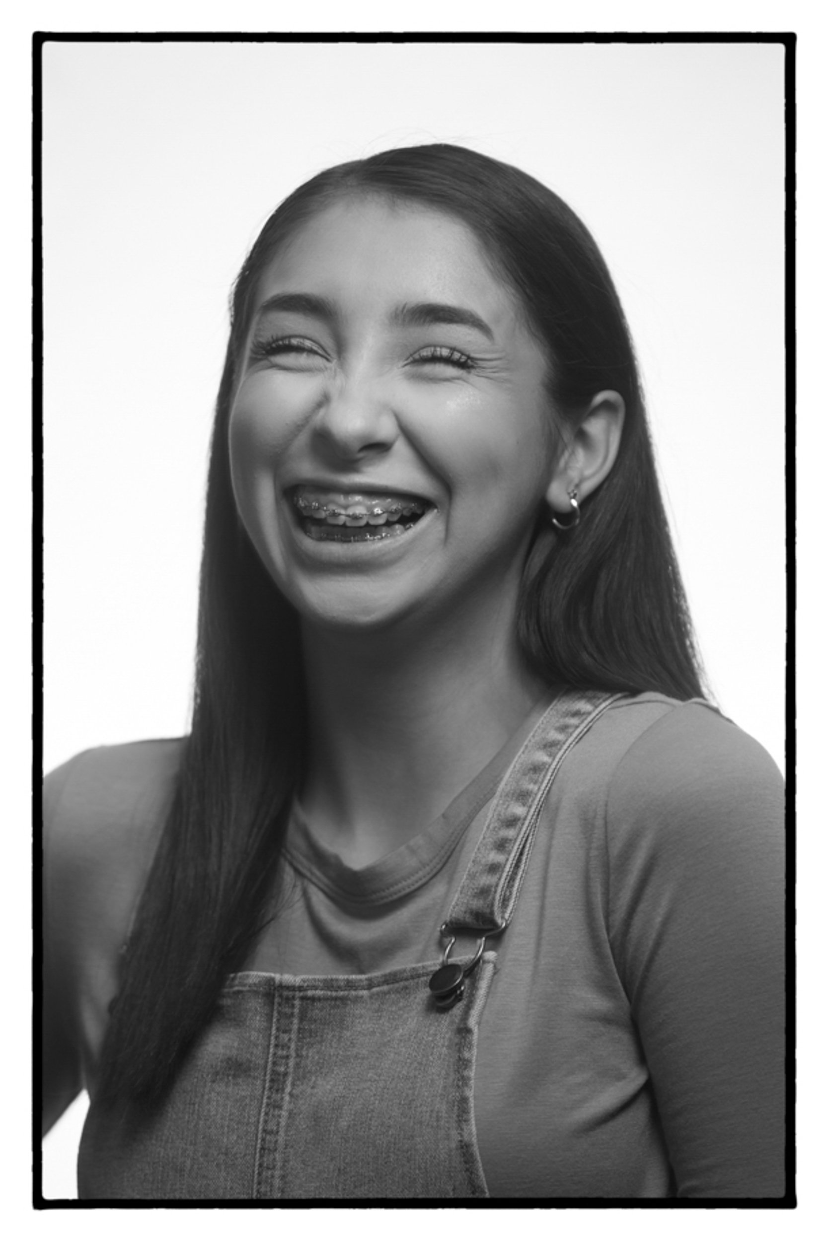 Black and white portrait of young girl laughing