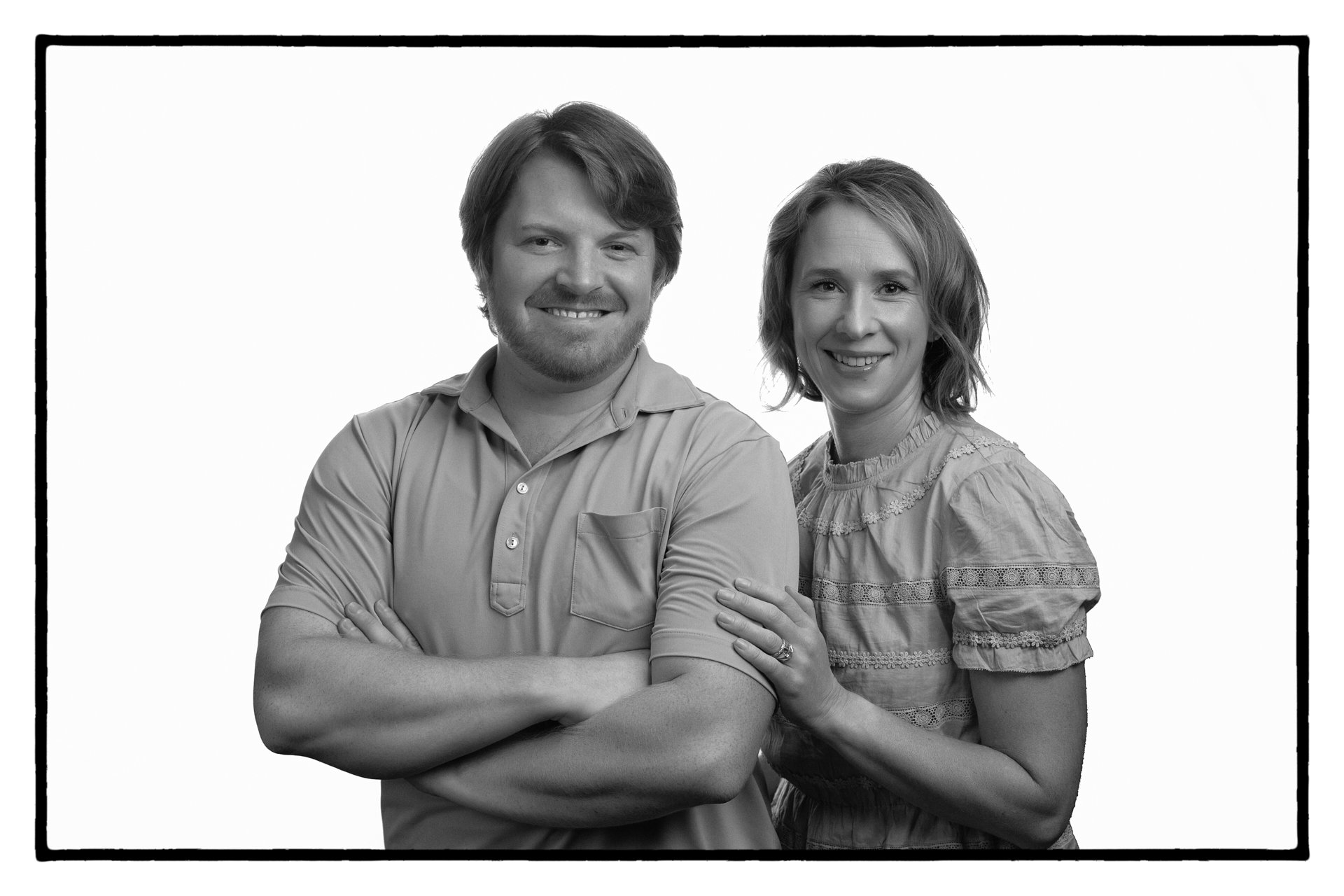 black and white portrait of couple woman has her hand on his shoulder