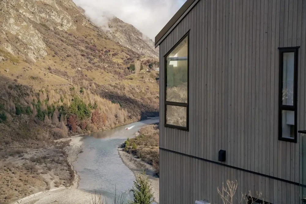 Large home by a river and mountain