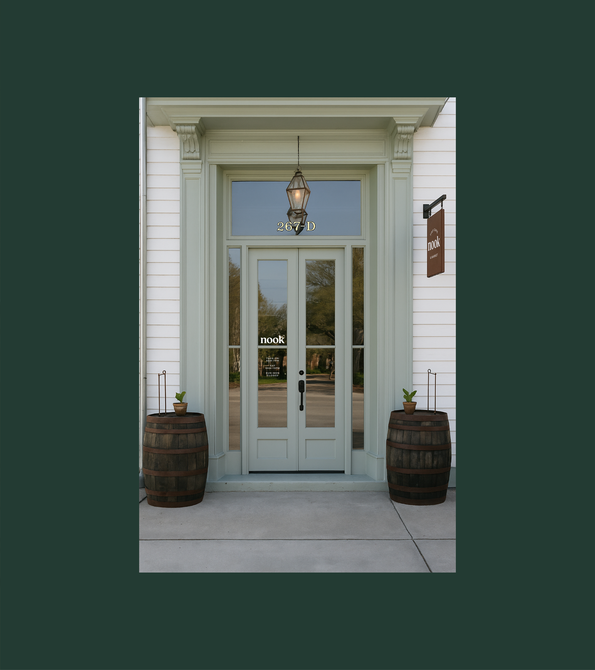 Storefront entrance with glass double doors, potted plants in wooden barrels, a hanging lantern, and signs displaying the store name 'nook'.