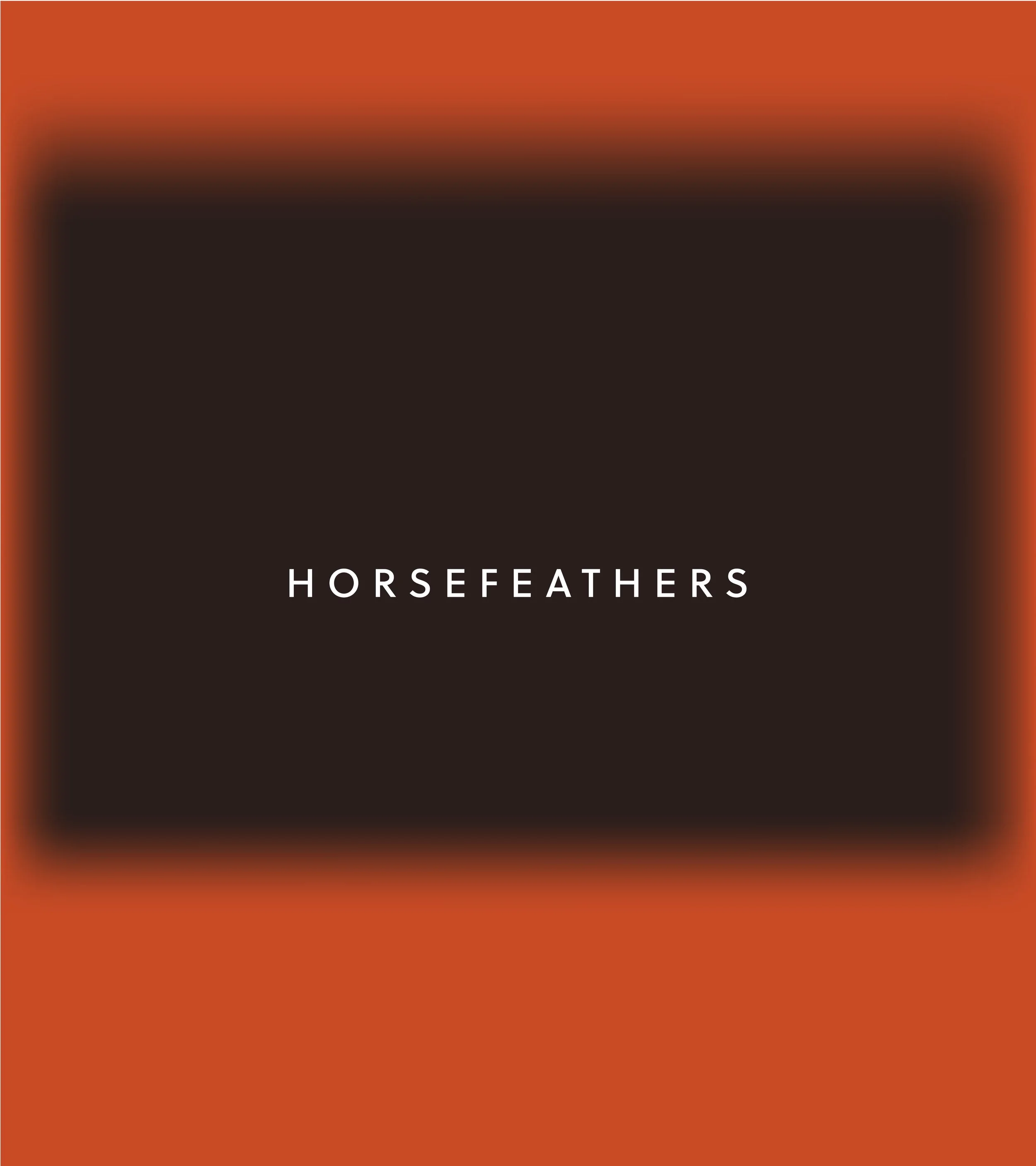 Product packaging of Horsefeathers, with a black central rectangle and a reddish-orange border.