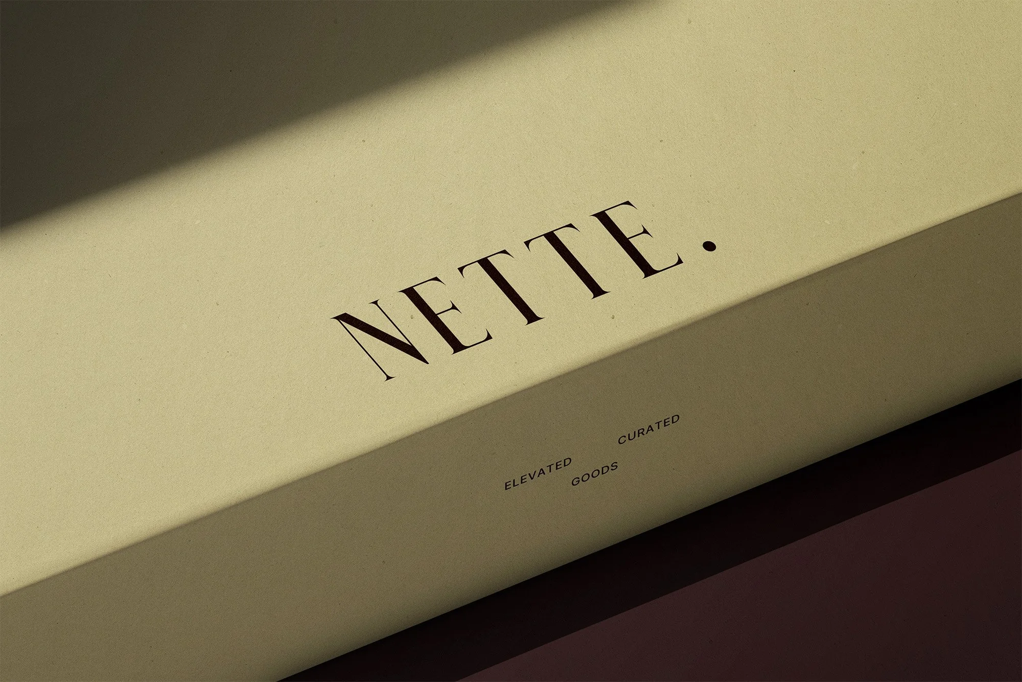 A beige box with the word 'NOTE' printed on it in large, black letters. Smaller text below reads 'ELEVATED CURATED GOODS.'