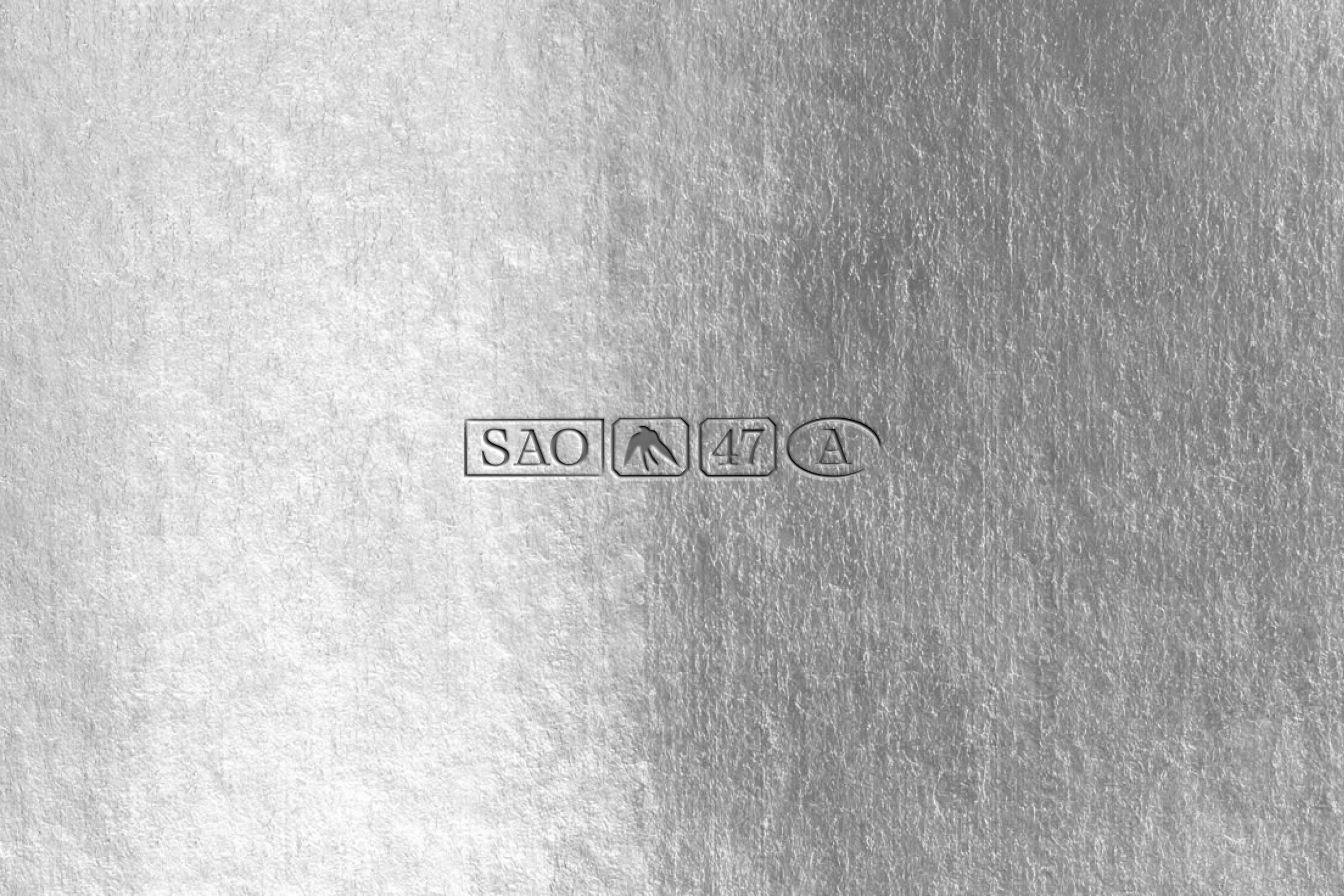 Close-up of a metallic surface with engraved markings: 'SAO,' a bird symbol, the number '47,' and a letter 'A'.