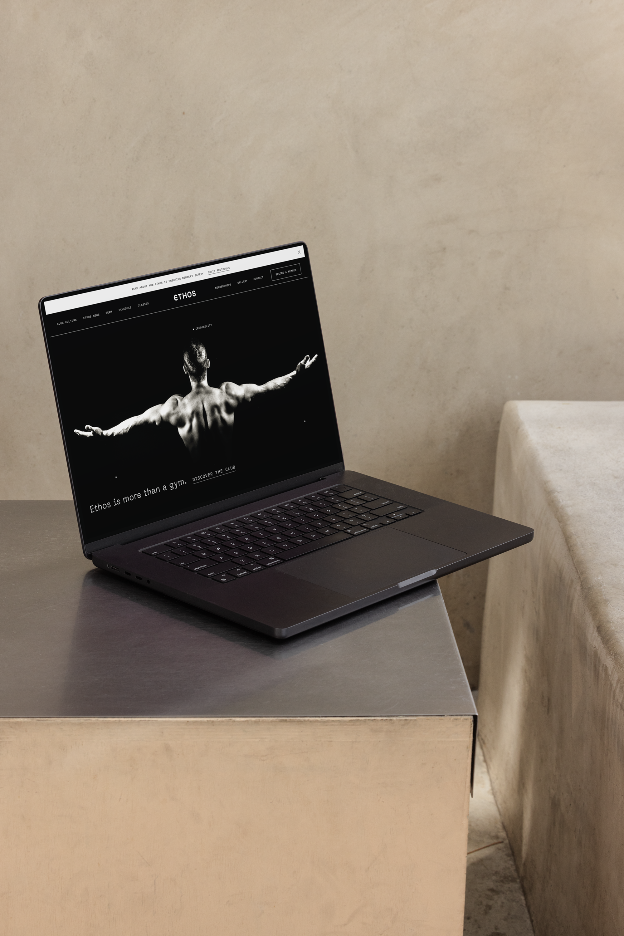 Man holding an iPhone with the Ethos Athletic Club homepage on the screen, a website designed by Studio Margo Garrigues