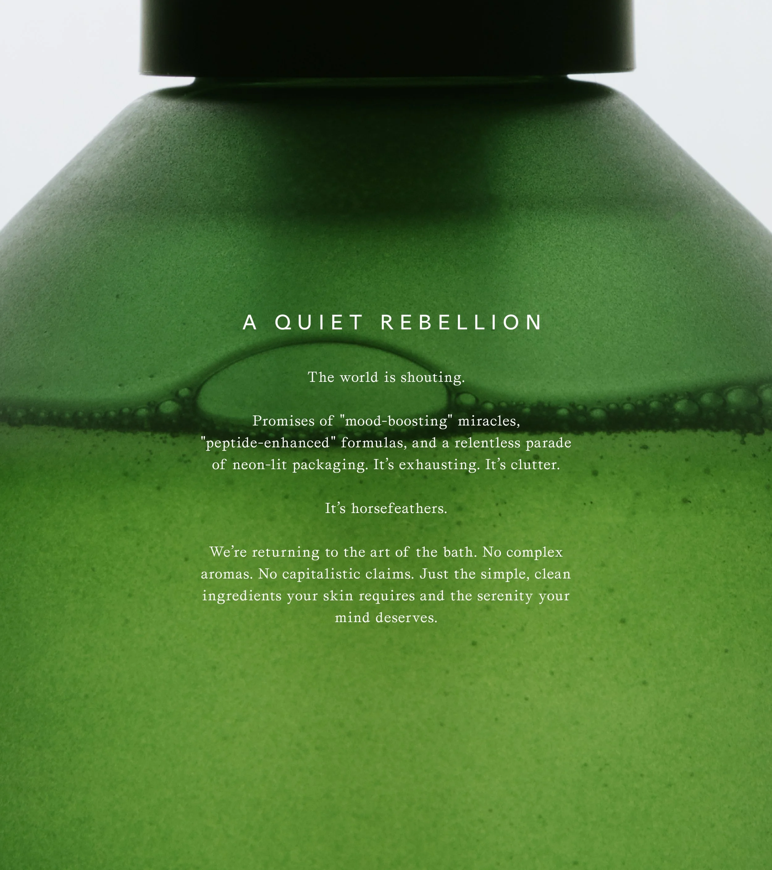 Close-up of a green bath product container with white text describing its natural ingredients and philosophy.