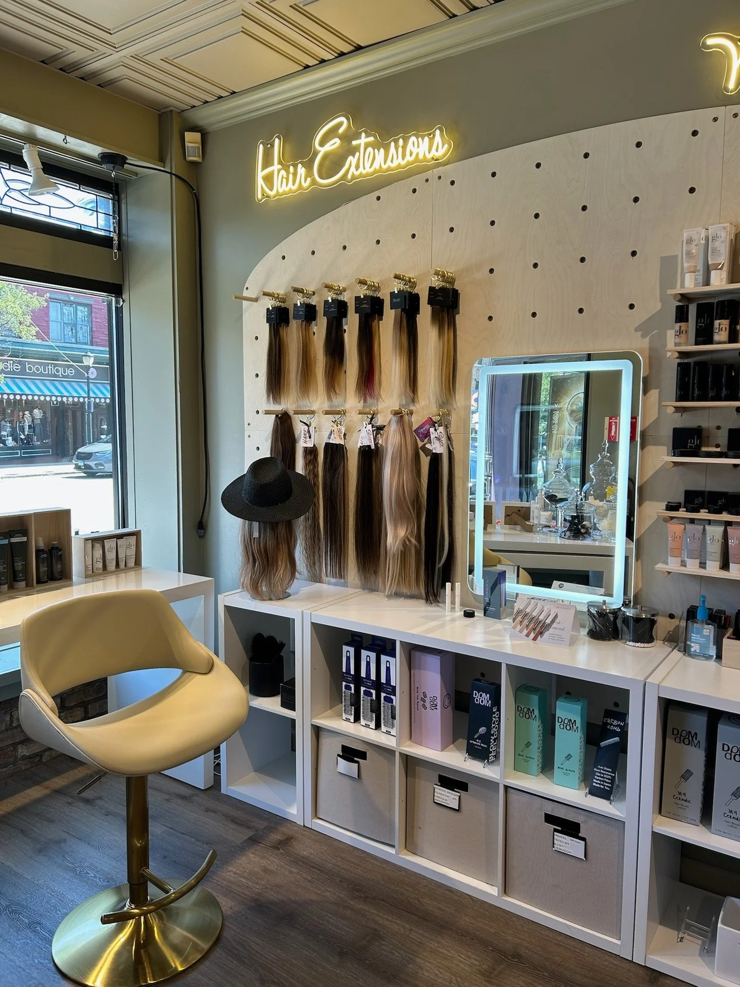 This cute corner is our new Makeup + Extensions Consult Bar at Allure. Try on shades, color match, feel real extension hair, and map out your look, maintenance, and budget with a pro. Ready to plan your glow up? Book your consult at the link in bio o