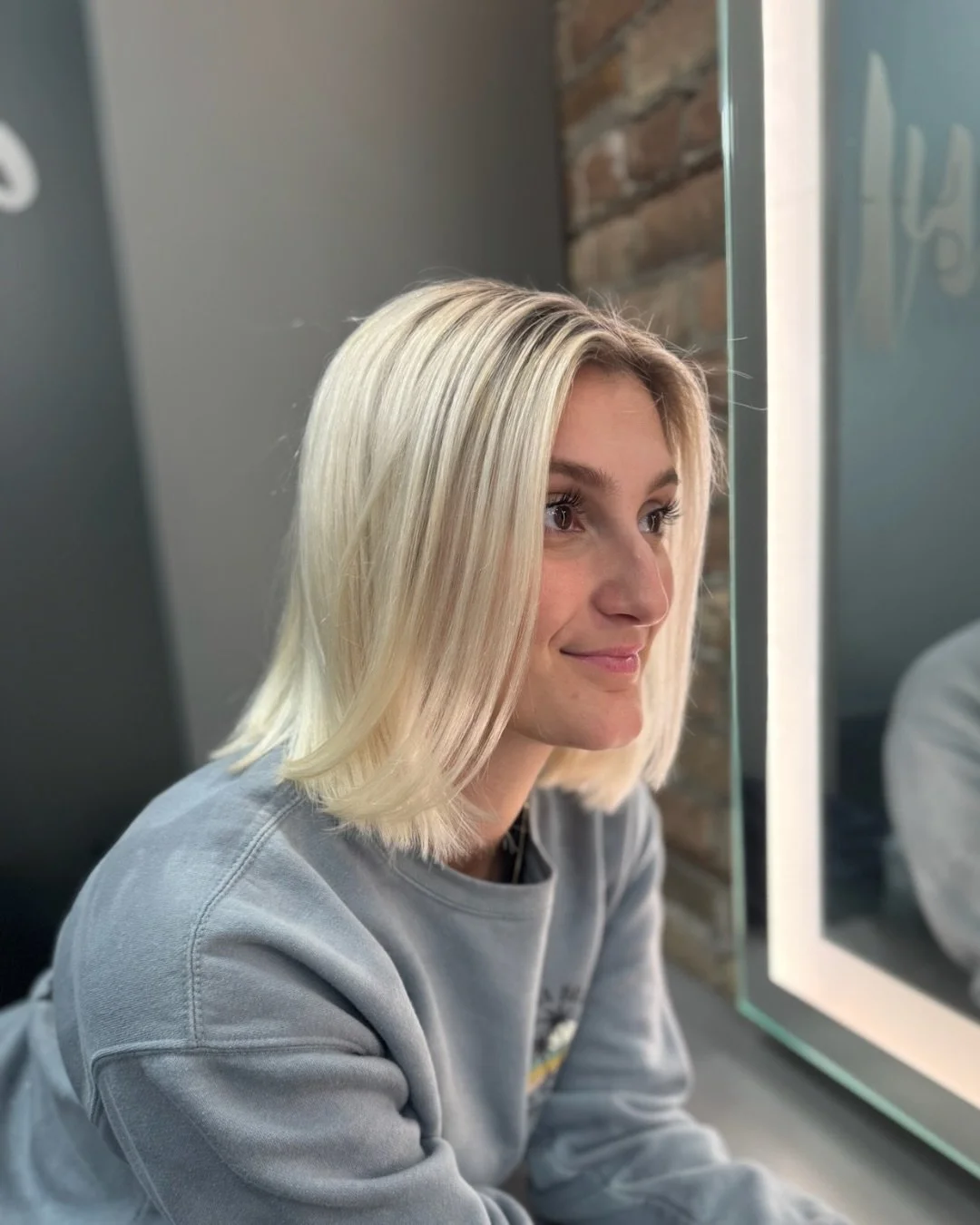 Shelly started Carmela&rsquo;s transition from a double process blonde into a babylight blonde, focusing on breaking up that harsh regrowth and creating dimension that will grow out more naturally.

This is after just one visit. You can already see t