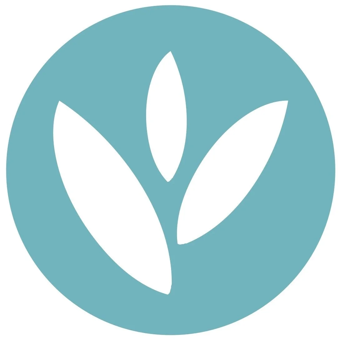 Columbus Womens Wellness logo Teal circle with white leaf shapes