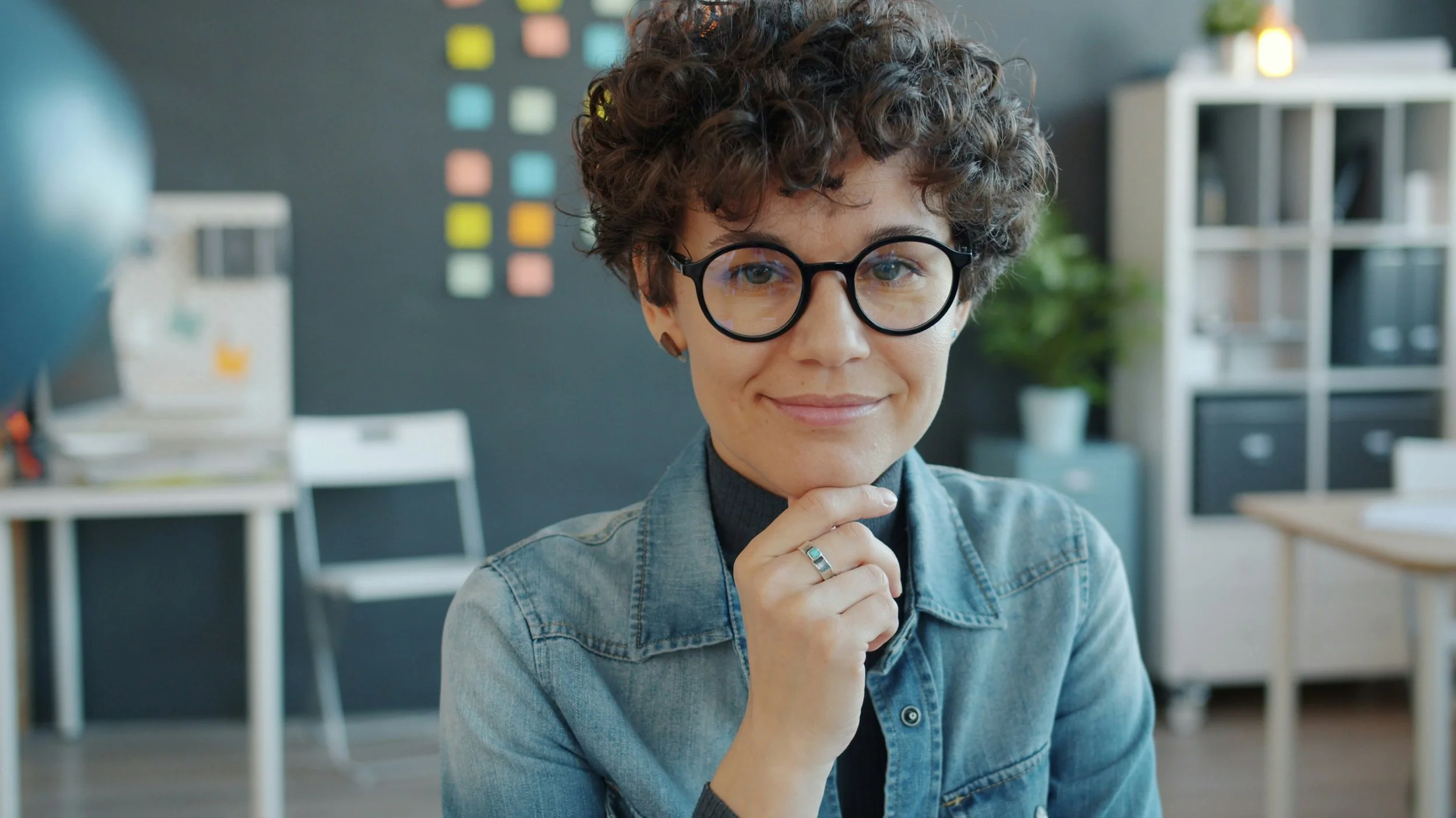 New therapist sitting thoughtfully in an office, representing the uncertainty and self-doubt that can come early in a therapy career.