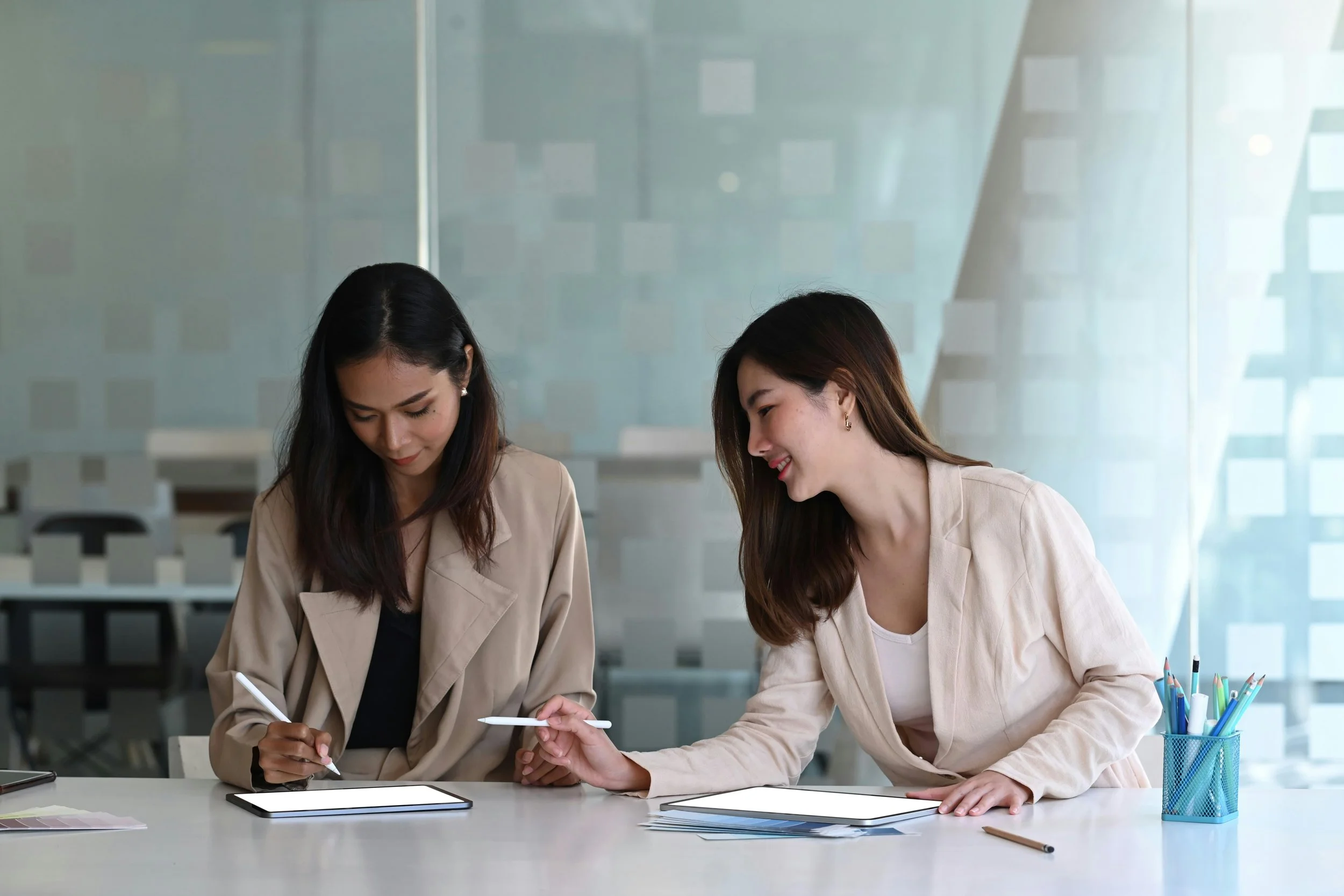 A clinical supervisor and therapist in training meeting in a professional office setting to discuss cases and support clinical growth.