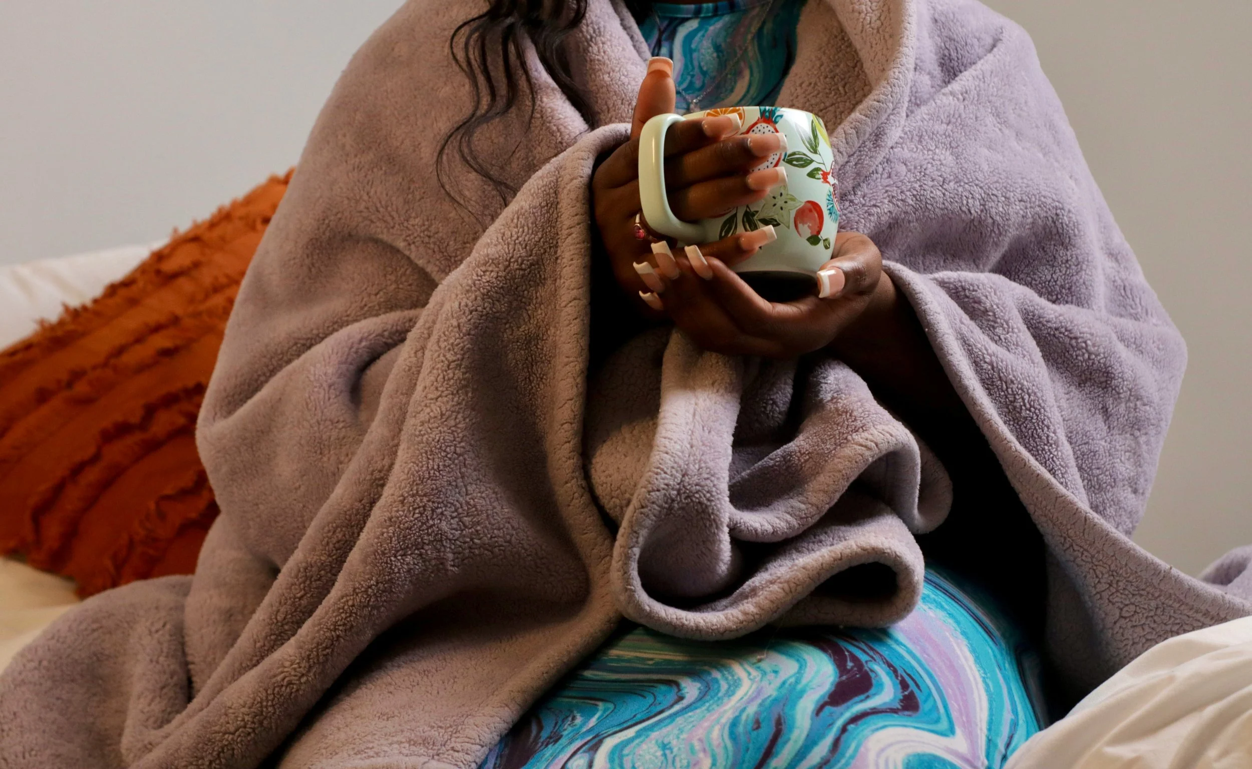 Therapy graduate student taking a calming self-care break while wrapped in a cozy blanket.
