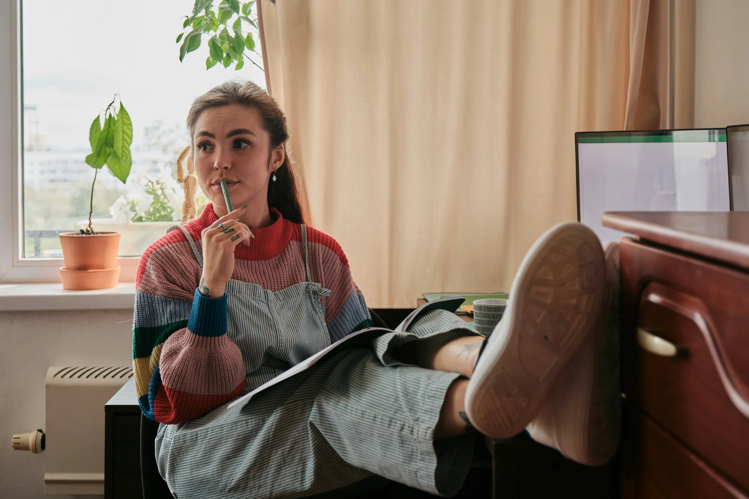 Young college student studying and reflecting on future career options in mental health and therapy training programs