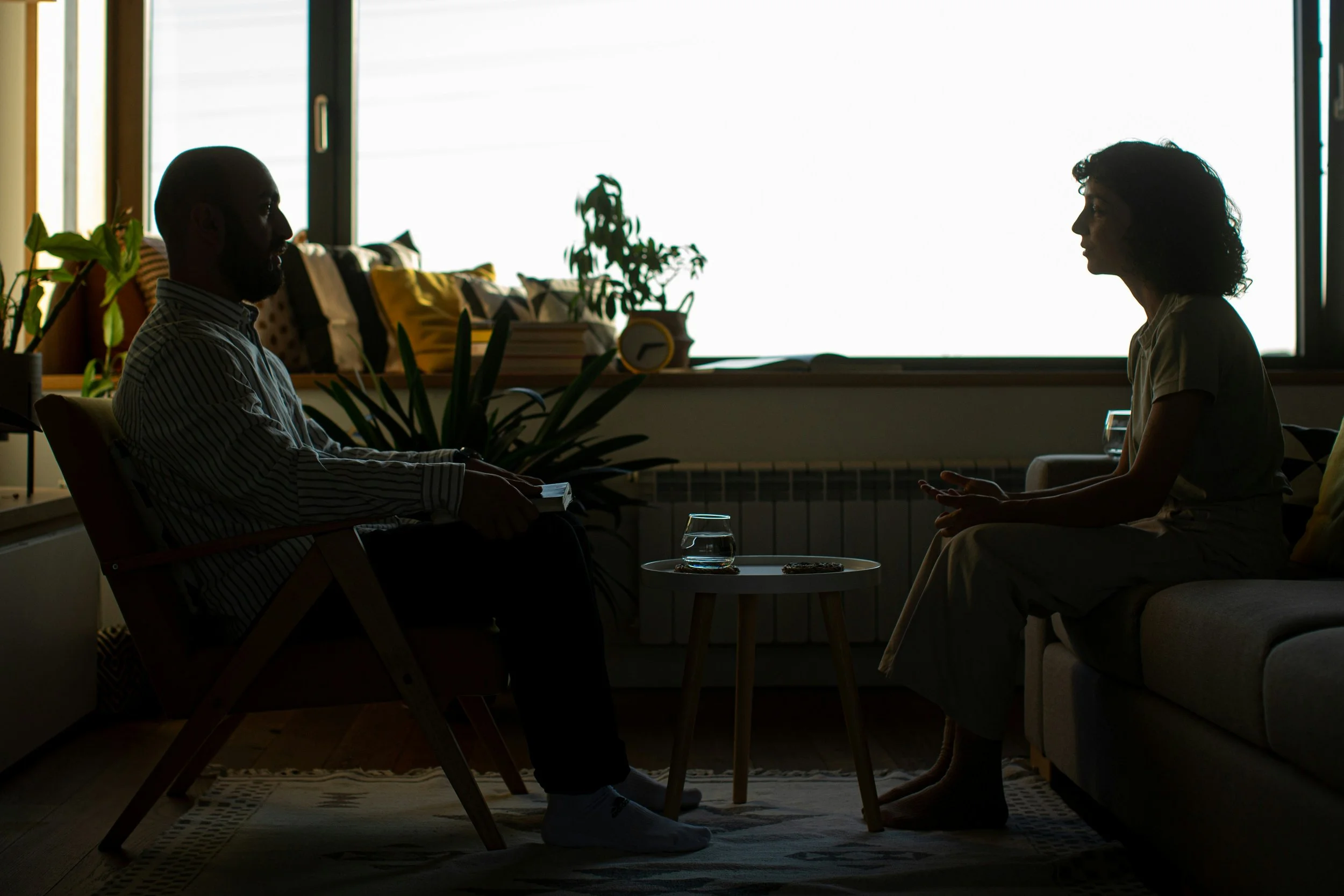 Graduate student therapist reviewing notes before first client session, representing anxiety in early therapist training.