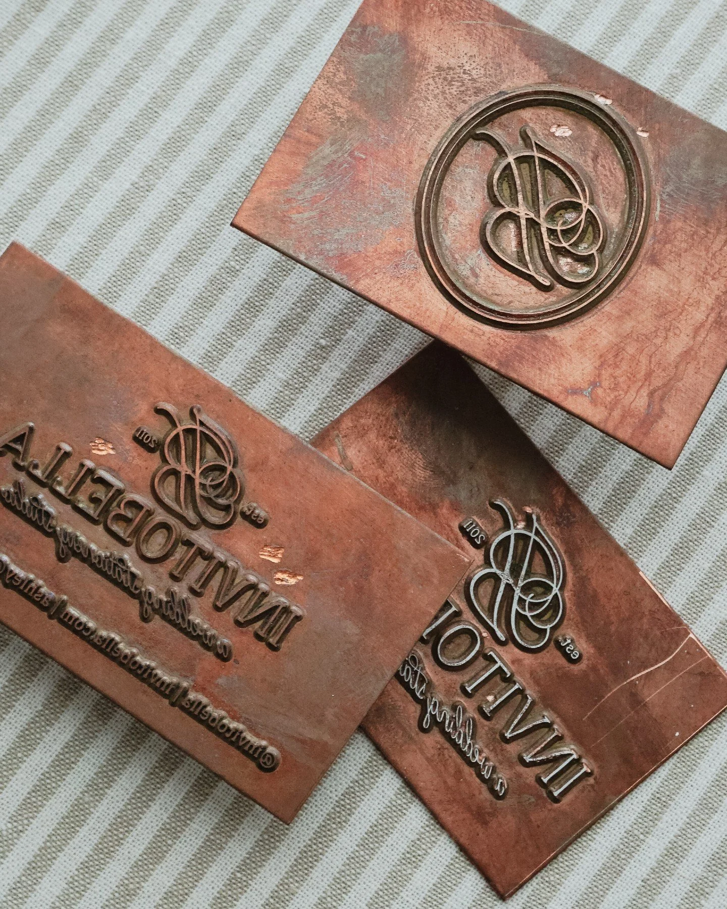 Before the gold foil, there's the copper.

These are the plates that live behind every foil-stamped piece that leaves this studio. Etched with intention, reversed in mirror image, and made to hold heat and pressure until something luminous transfers 
