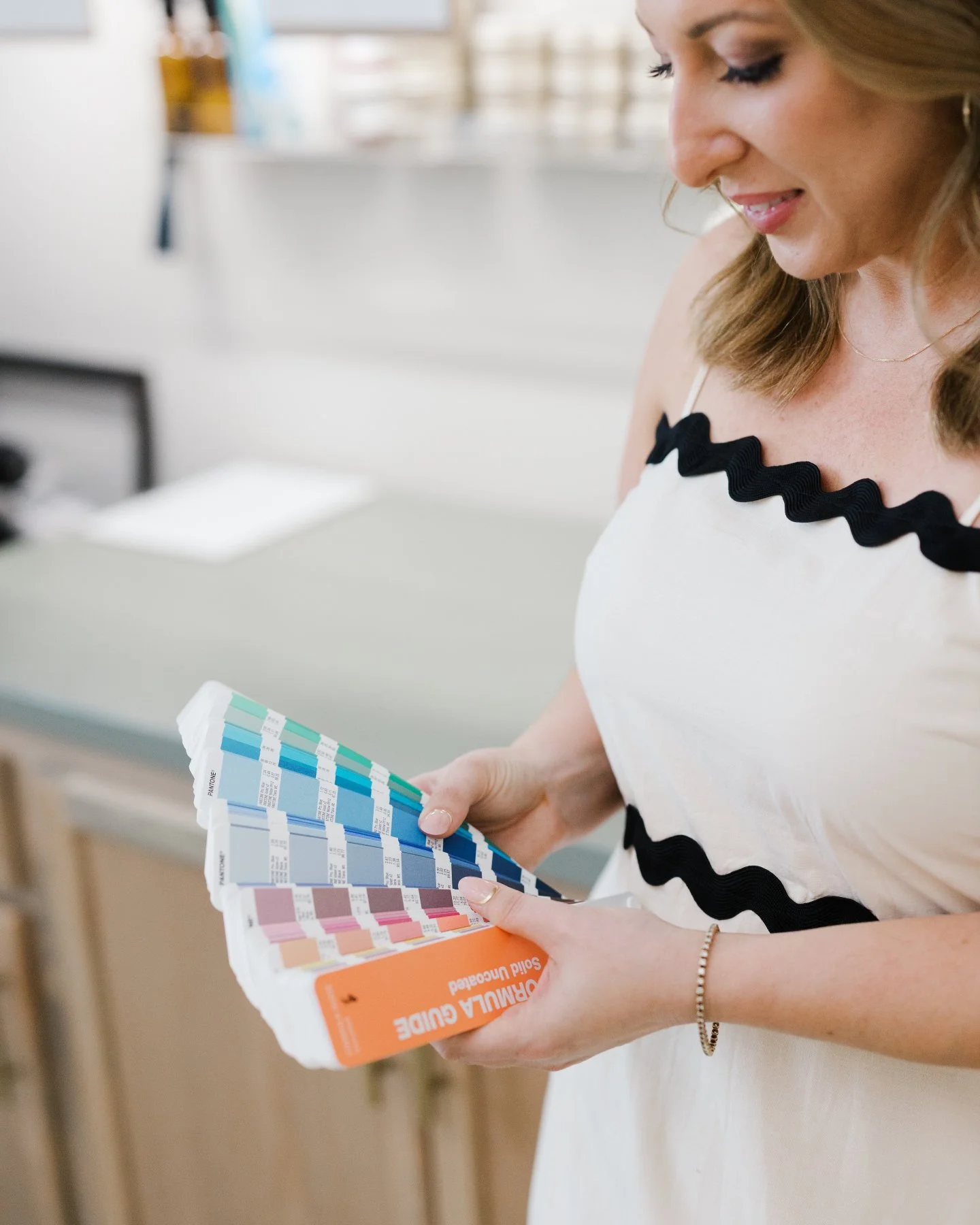 There is a moment before any of it exists, before the paper or the press or the envelope, when a color has to be found.

Sometimes it comes from a ribbon you have been holding onto since the engagement party, or the green of the pines at the end of y