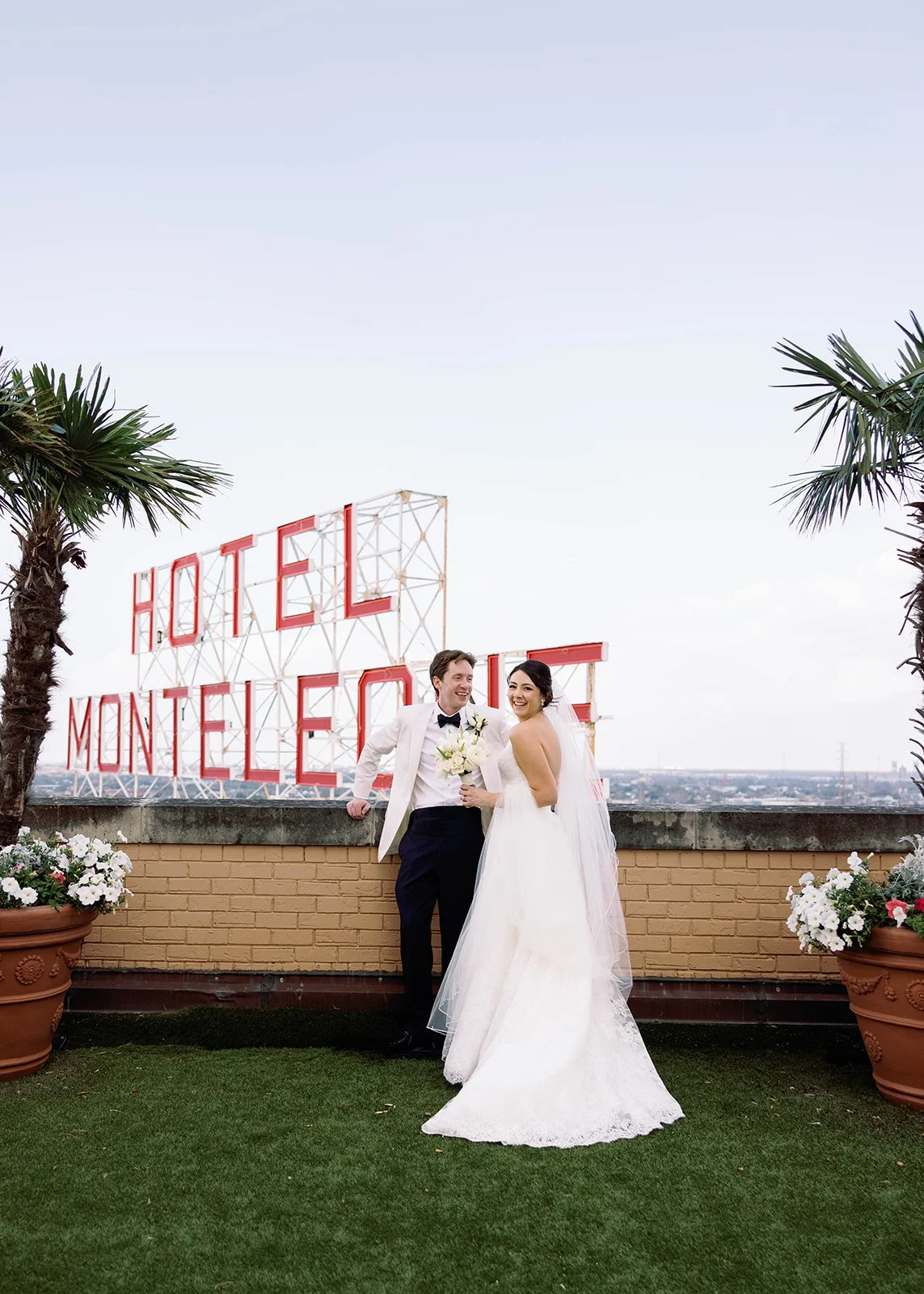 Bride and groom kissing on the rooftop of the Hotel Monteleone in New Orleans
