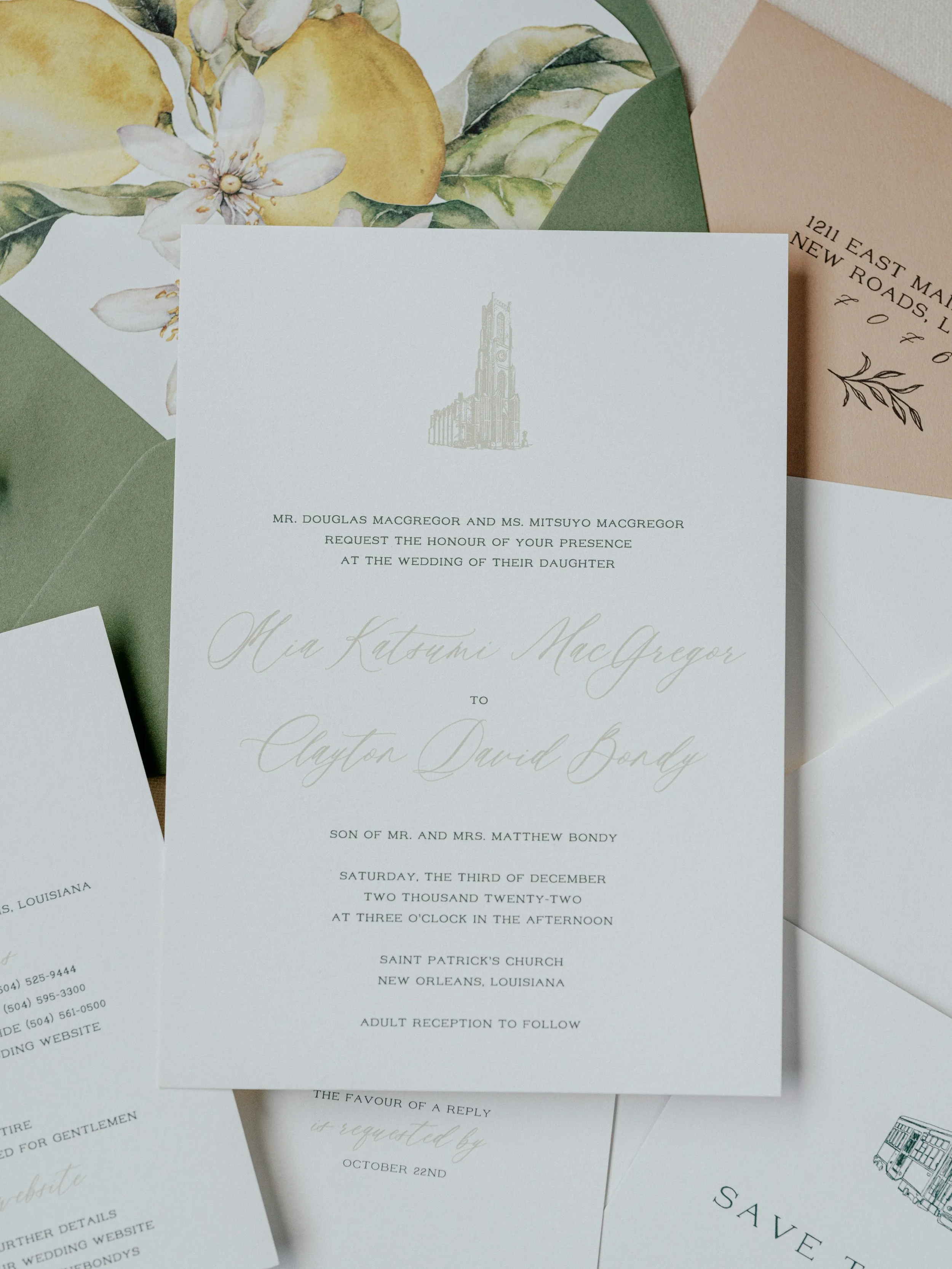 Wedding invitation with floral design and RSVP cards, featuring details for a ceremony at Saint Patrick's Church in New Orleans, Louisiana, and reception following.