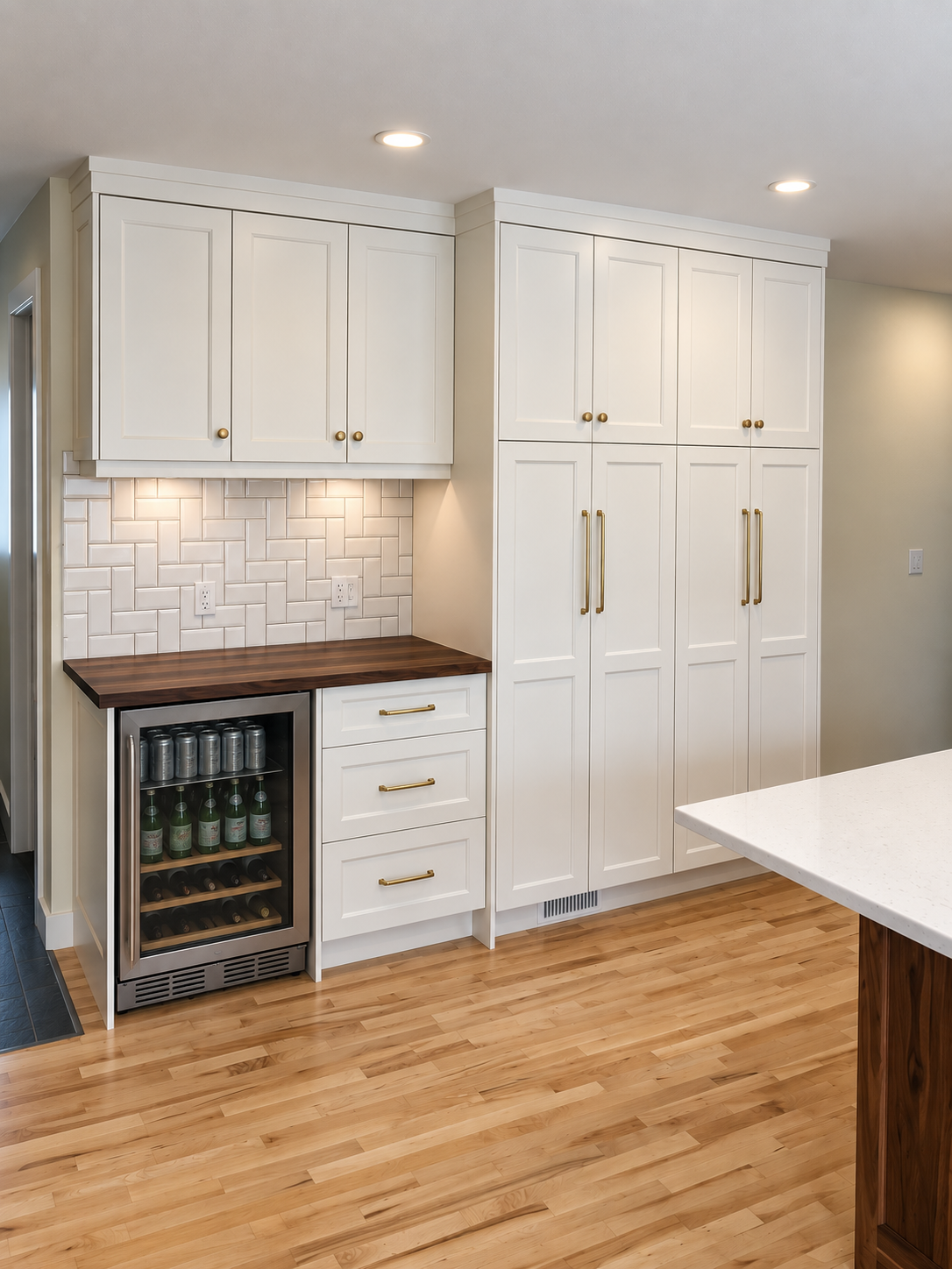 Custom built-in beverage centre with white cabinetry, wood countertop and wine cooler by Winters Woodworks.