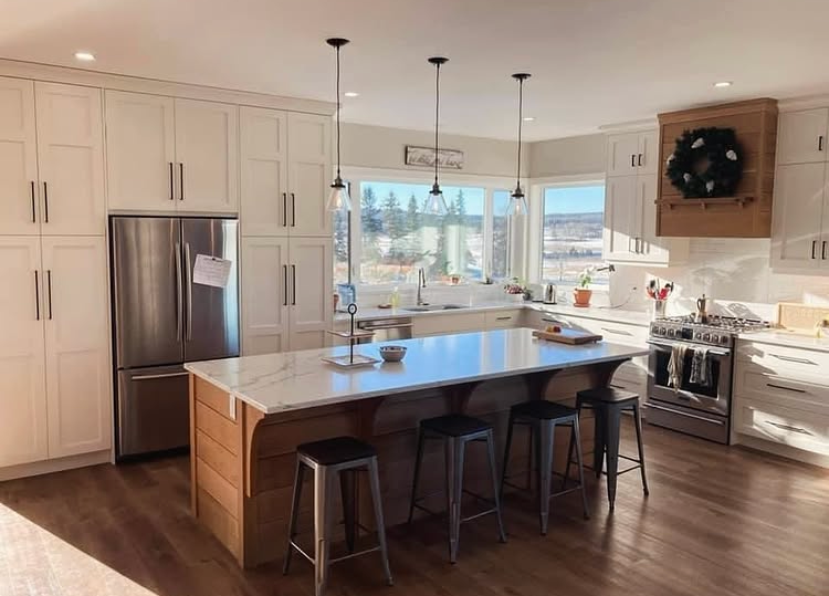 Custom kitchen with white cabinetry, white oak island and large windows in a Central Alberta home