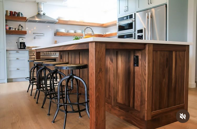 Custom walnut kitchen island with seating and detailed wood cabinetry by Winters Woodworks