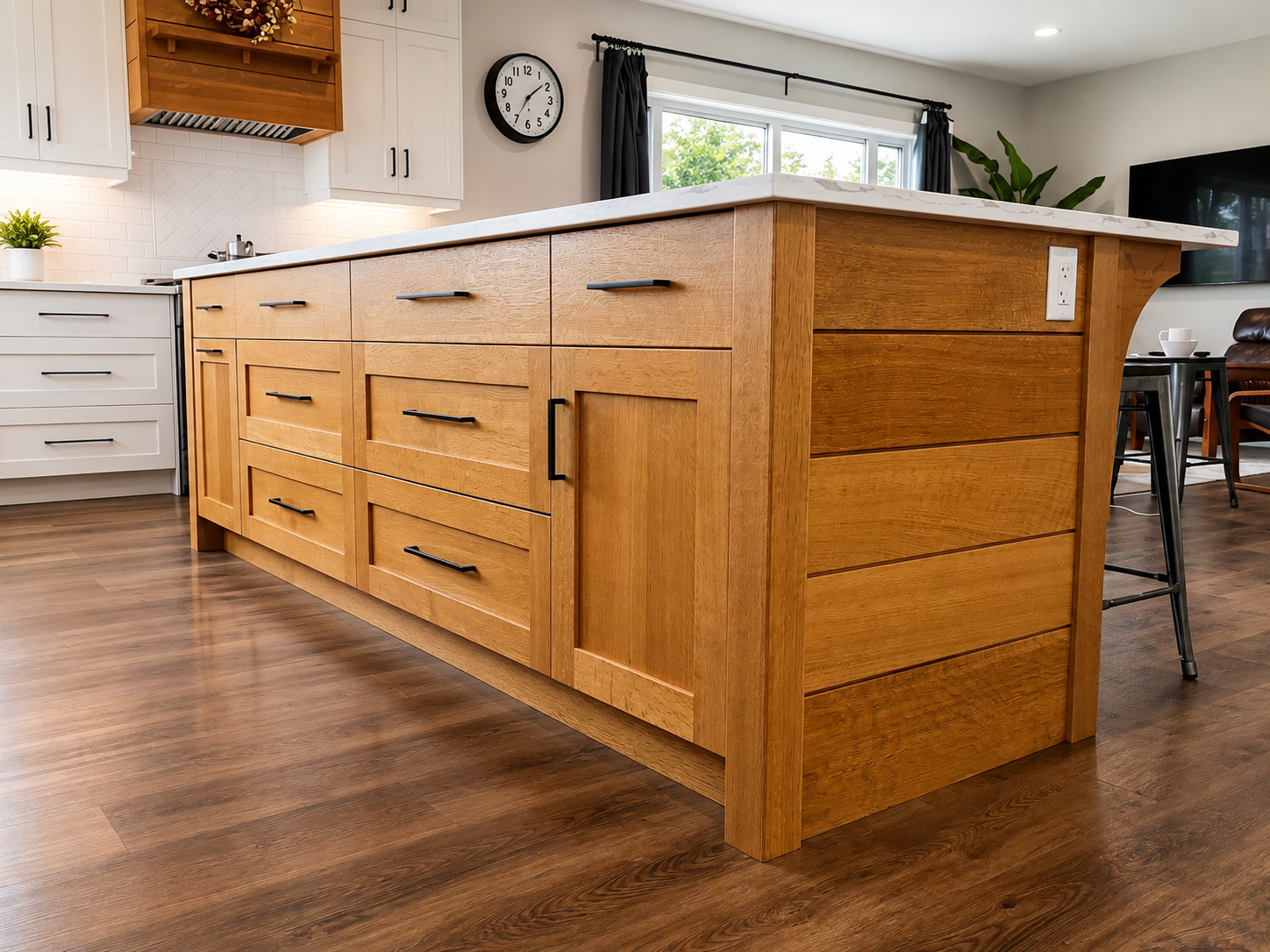 Custom natural white oak kitchen island with deep drawers, panelled ends and black hardware.