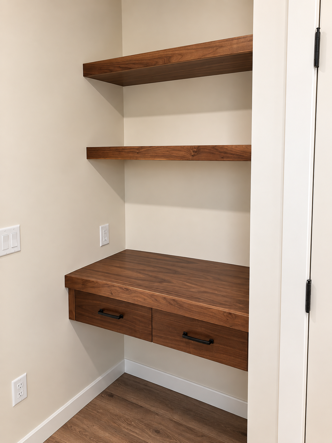Custom built-in wood desk with floating shelves, drawers and workspace storage.