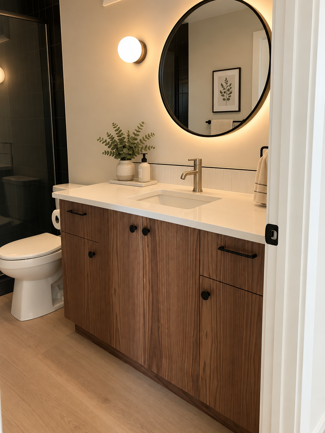 Custom walnut bathroom vanity with white countertop and black hardware by Winters Woodworks.