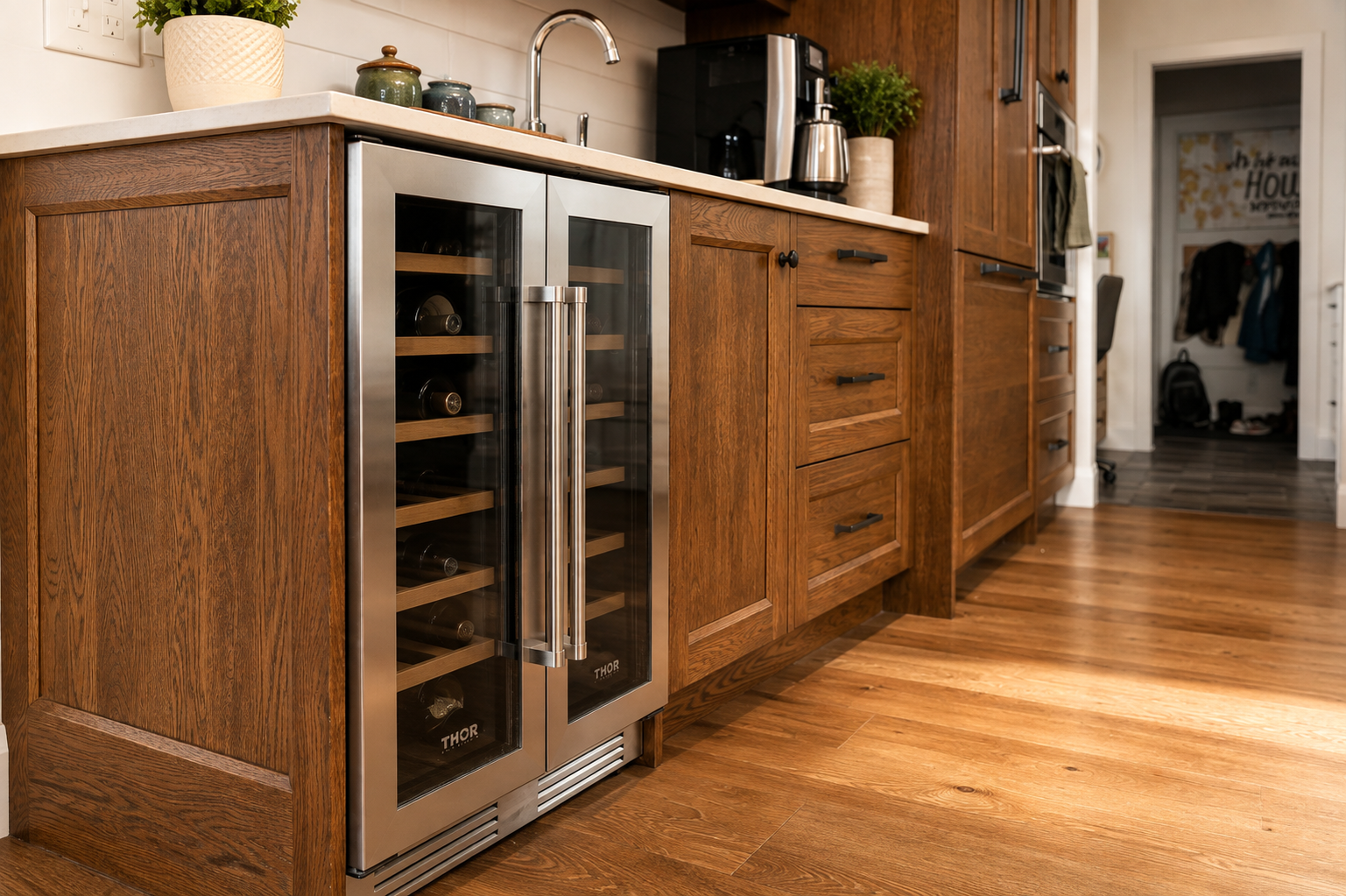 Custom wood cabinetry with integrated wine fridge, deep drawers and white countertop.