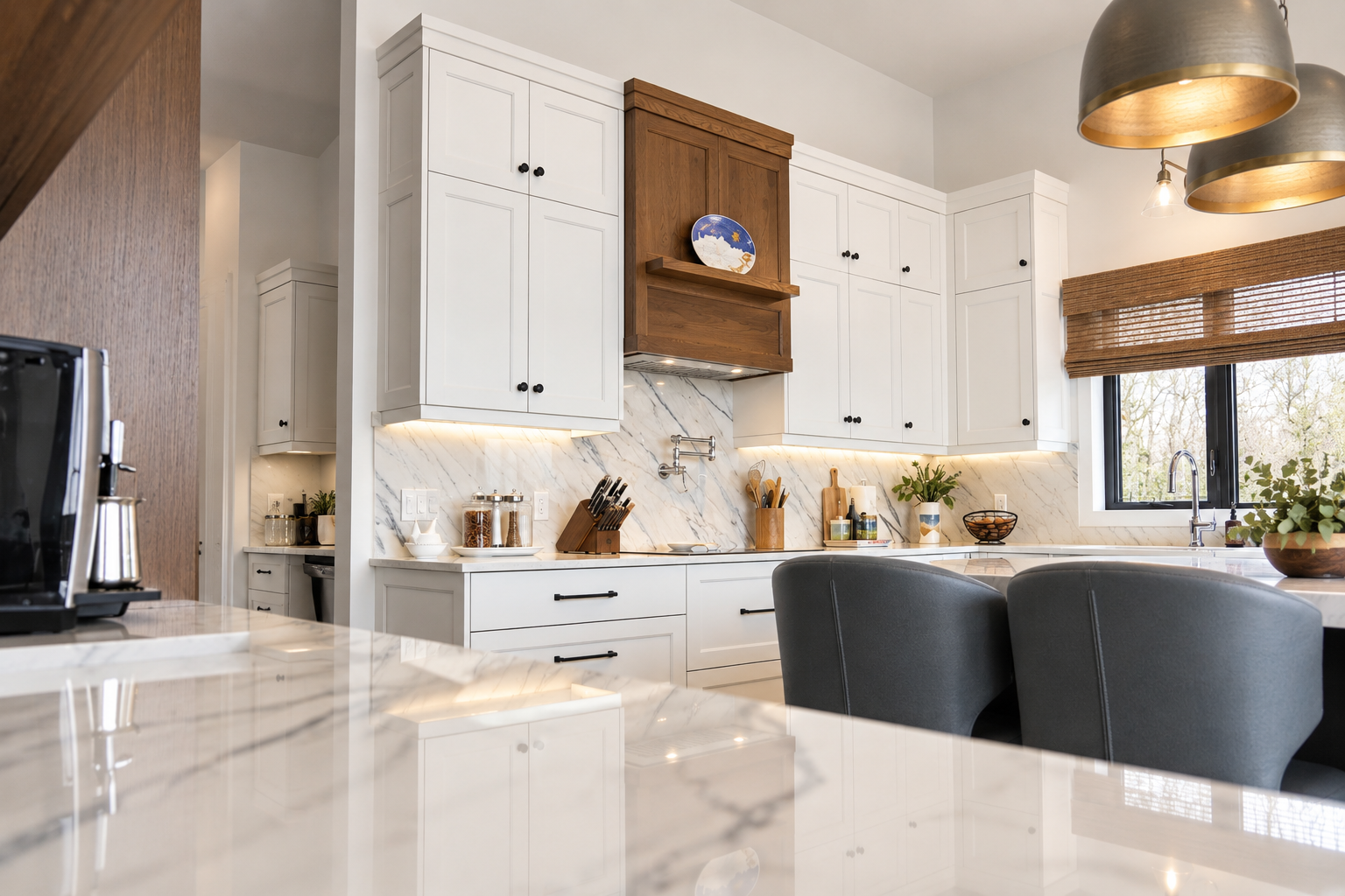 White custom kitchen cabinetry with black hardware, wood accents and stone backsplash.