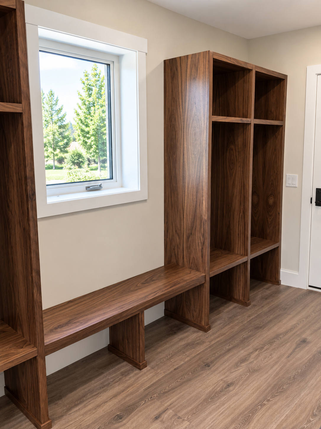 Custom wood mudroom built-in with bench seating, open shelving and floor-to-ceiling storage.