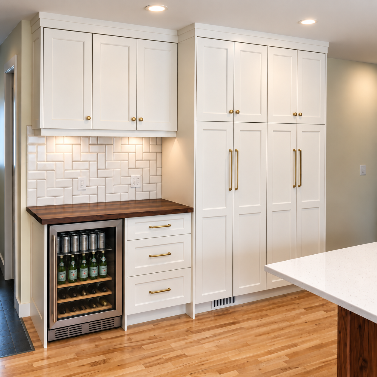 Floor-to-ceiling white custom cabinetry with walnut counter and built-in beverage fridge