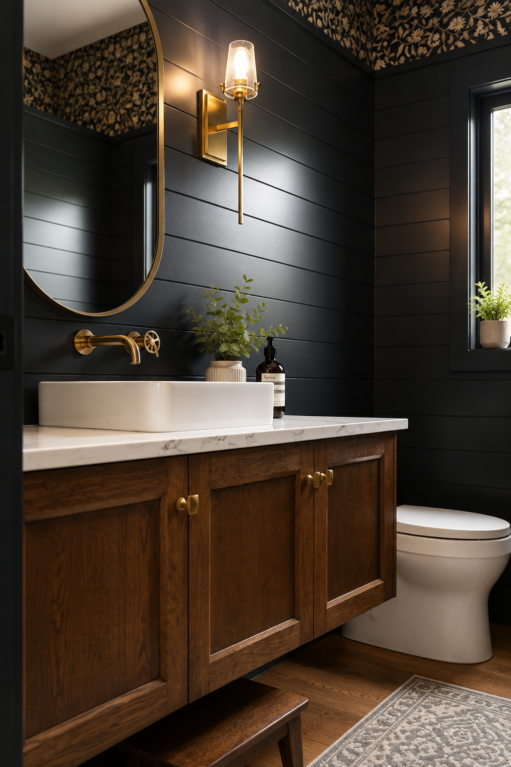 Custom dark wood bathroom vanity with paneled cabinetry, white stone countertop and gold fixtures.