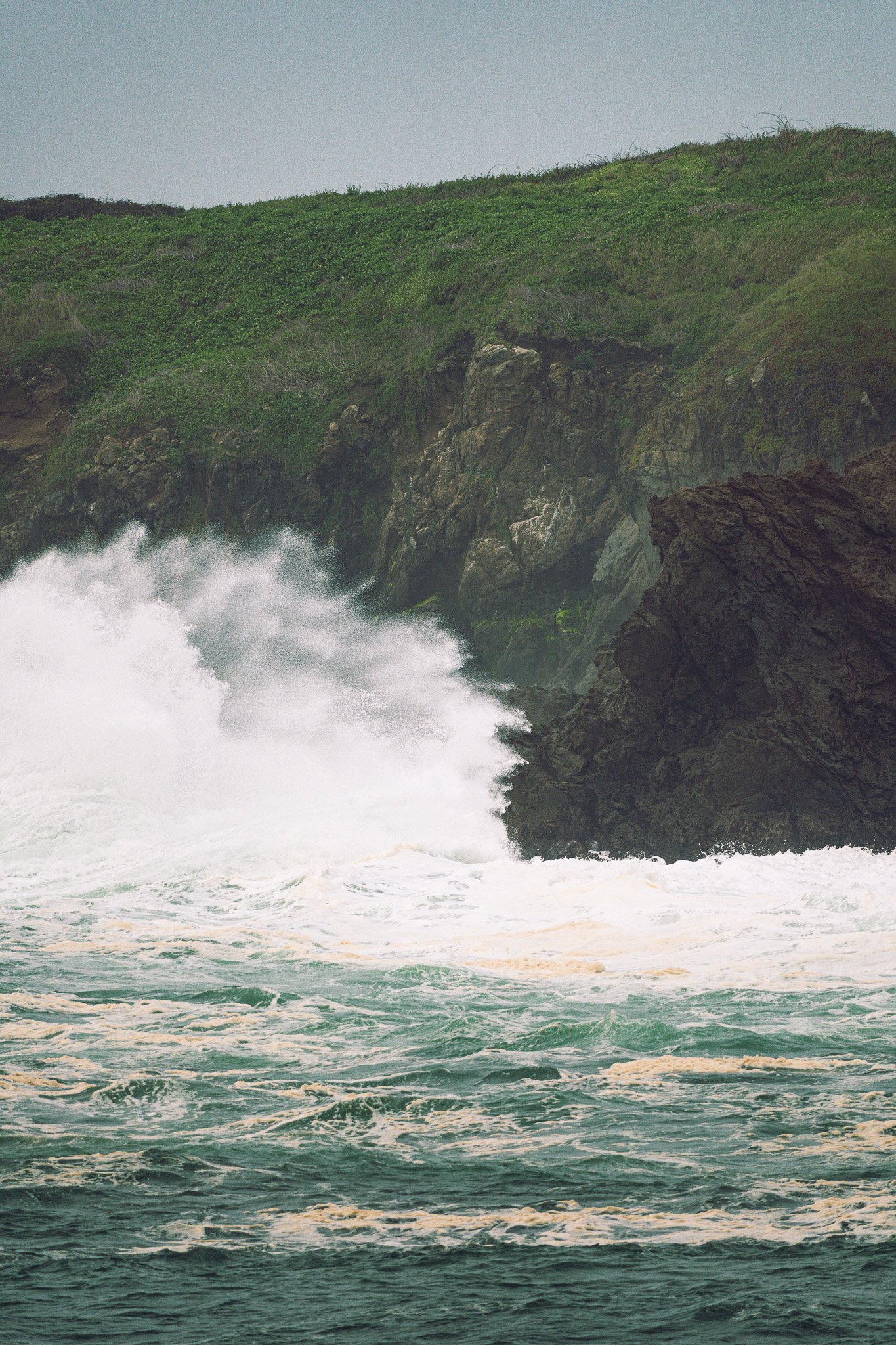 Storm wave crashing on rocks at Noyo Harbor, Fort Bragg