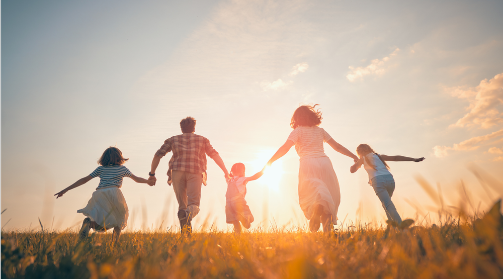 Family walking together at sunset