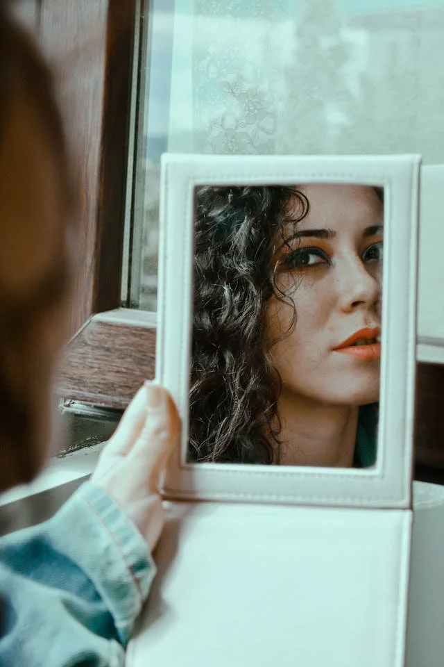A woman looking at herself in a mirror
