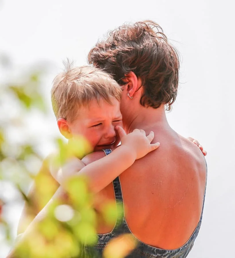 Parent holding crying child