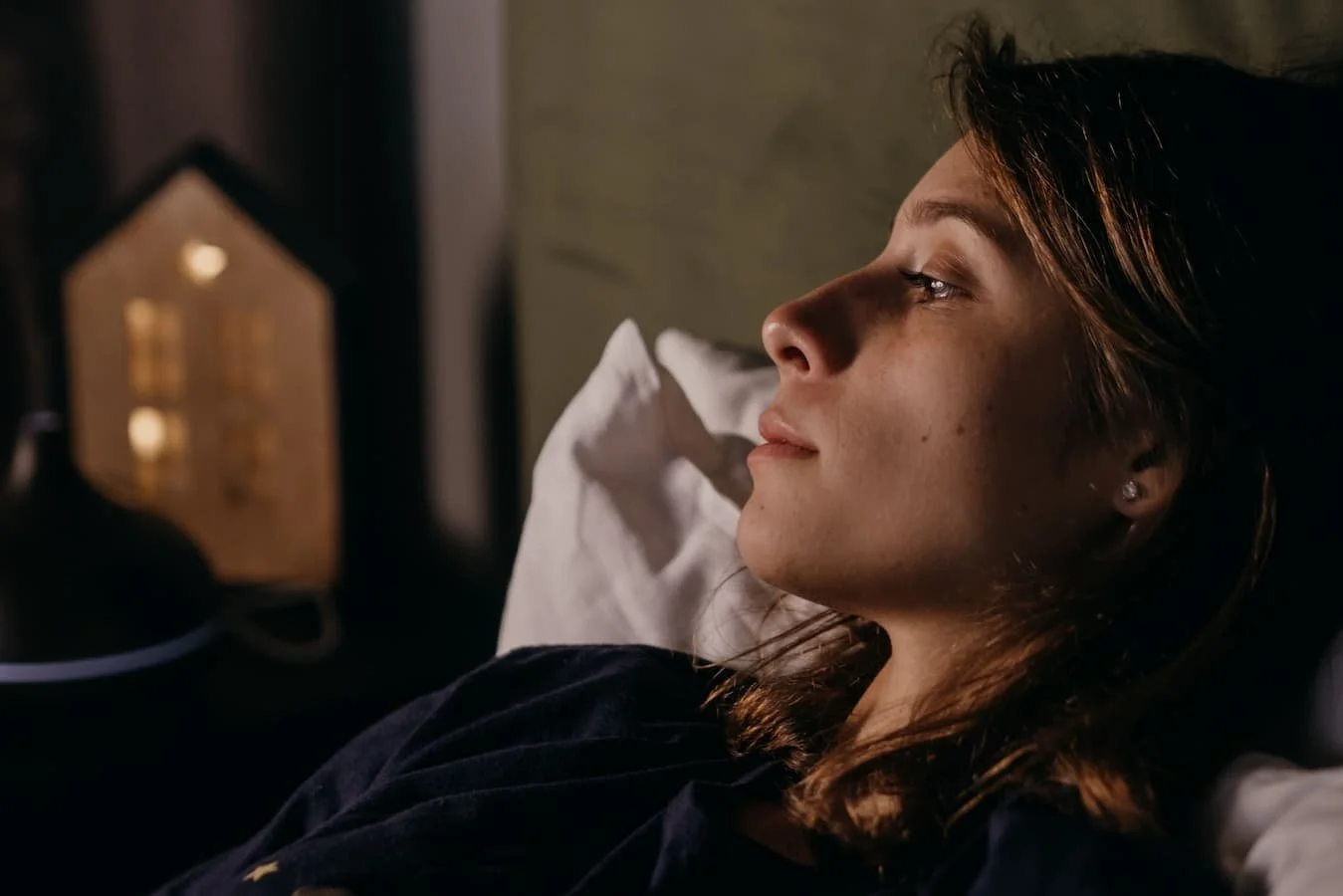 Person in bed looking worried