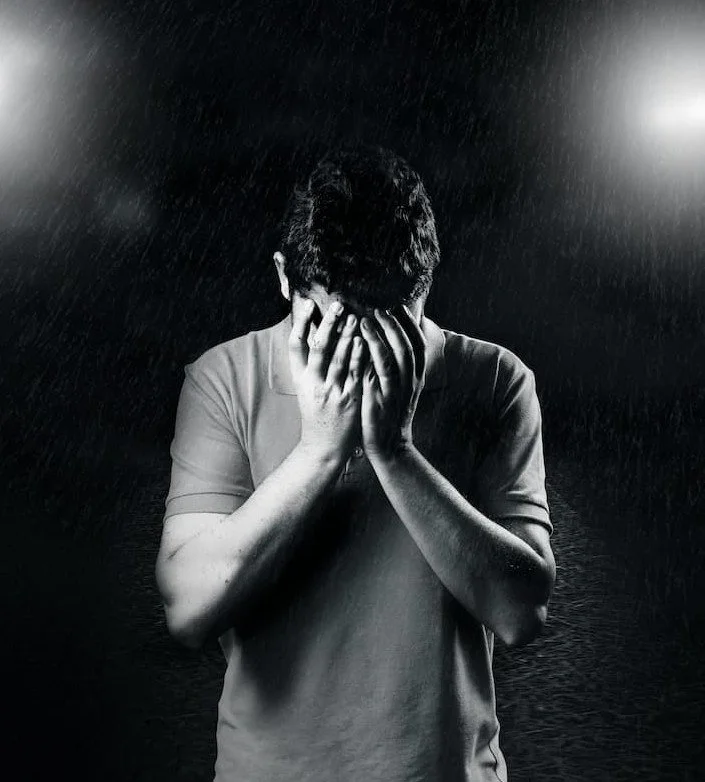 Man holding head in thought