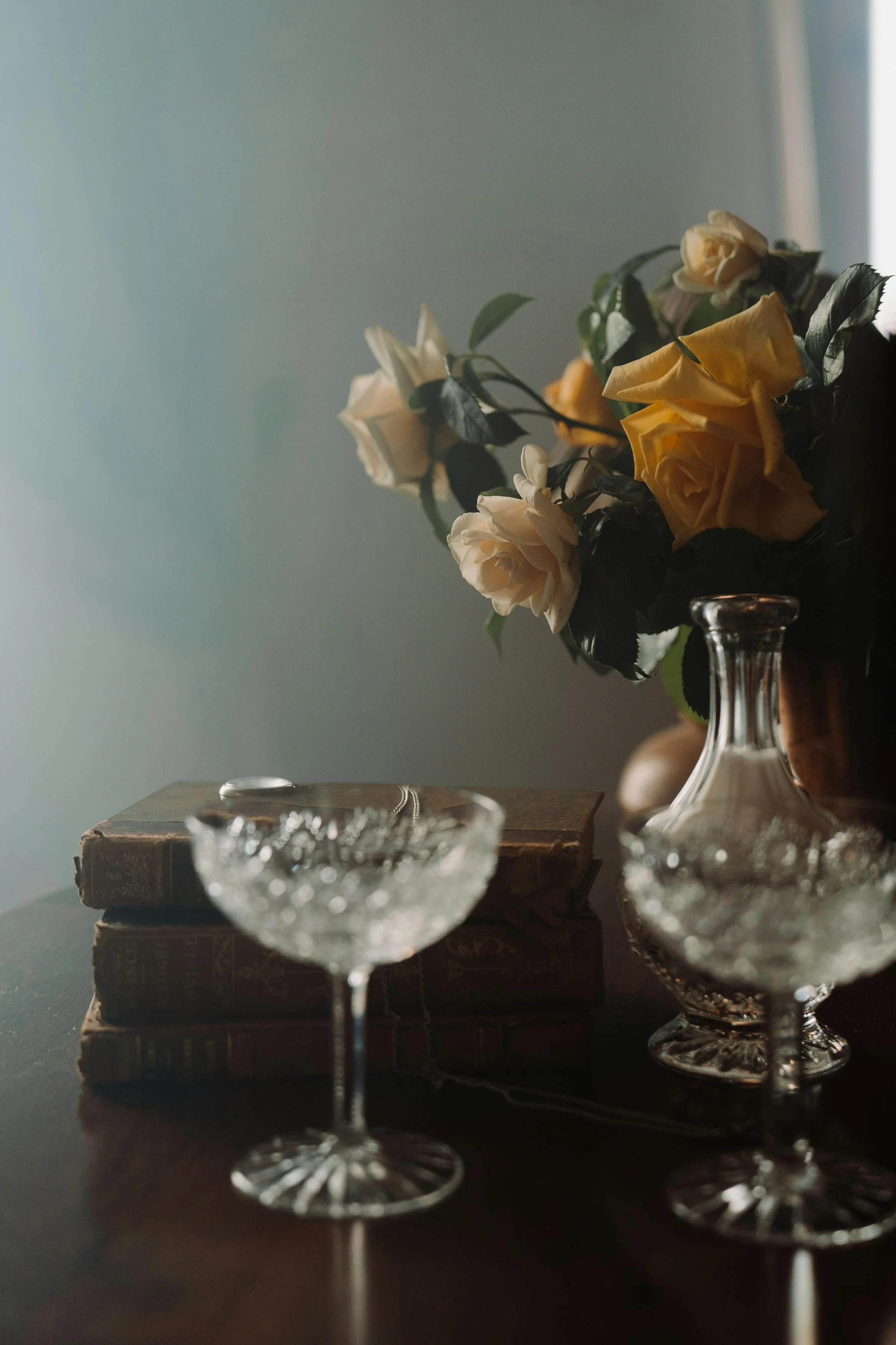Fancy drinkware with roses on a table. Moody fancy drinks.