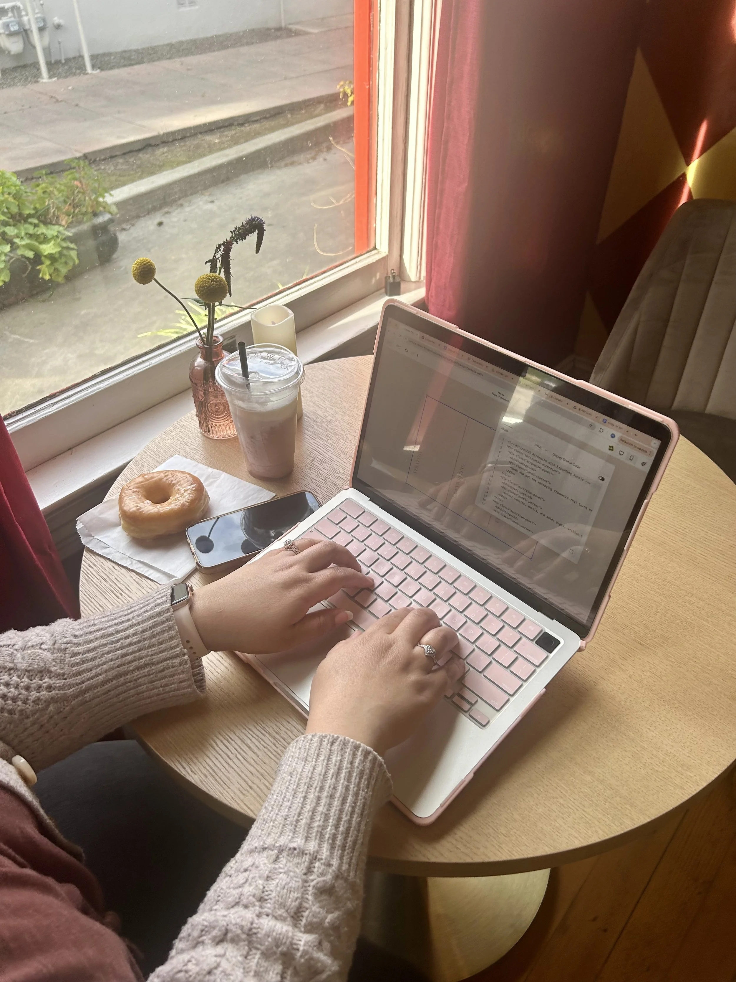 Female hands typing on computer with coffee near.