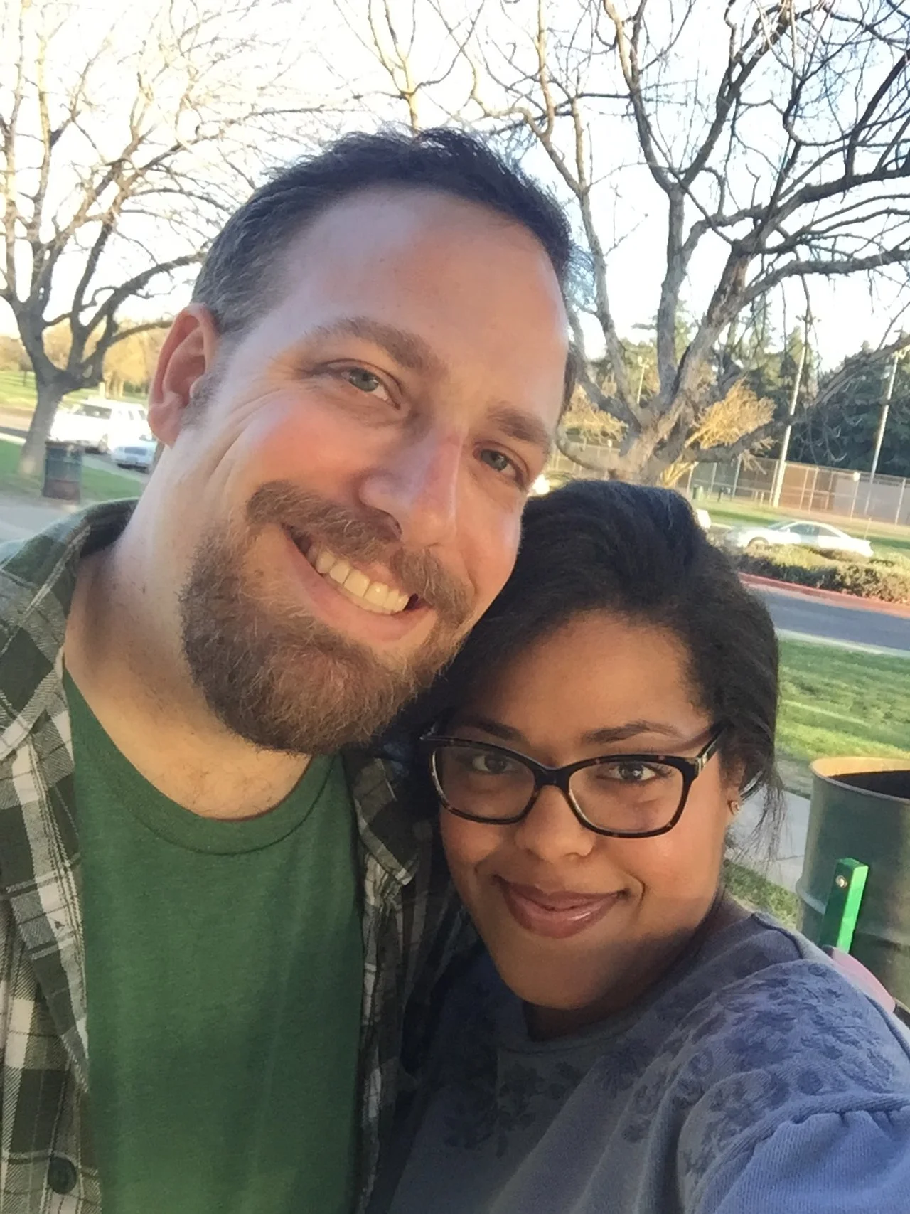 Man and woman smiling and hugging.
