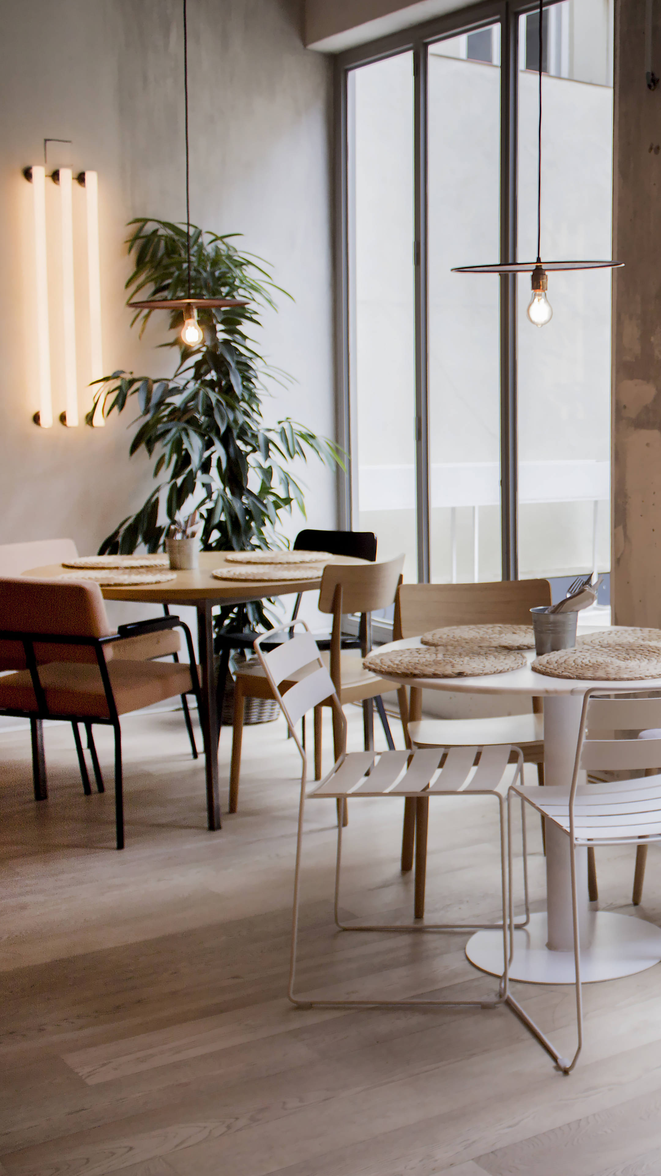 Interior del restaurante Massart Goya con ambiente cálido, mesas de madera y espacio para comidas, cenas y eventos en Madrid.
