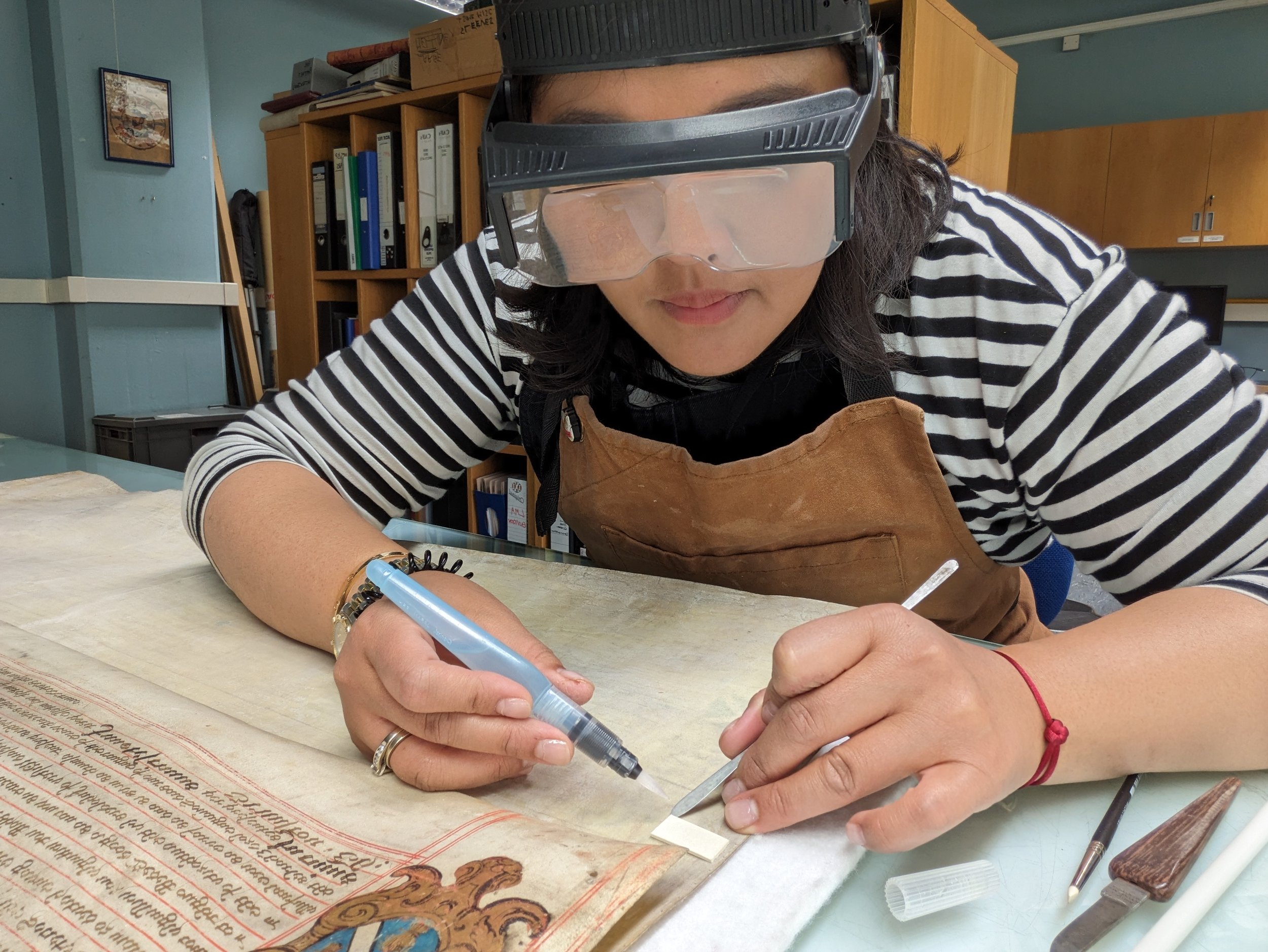 Adhesive removal from parchment document