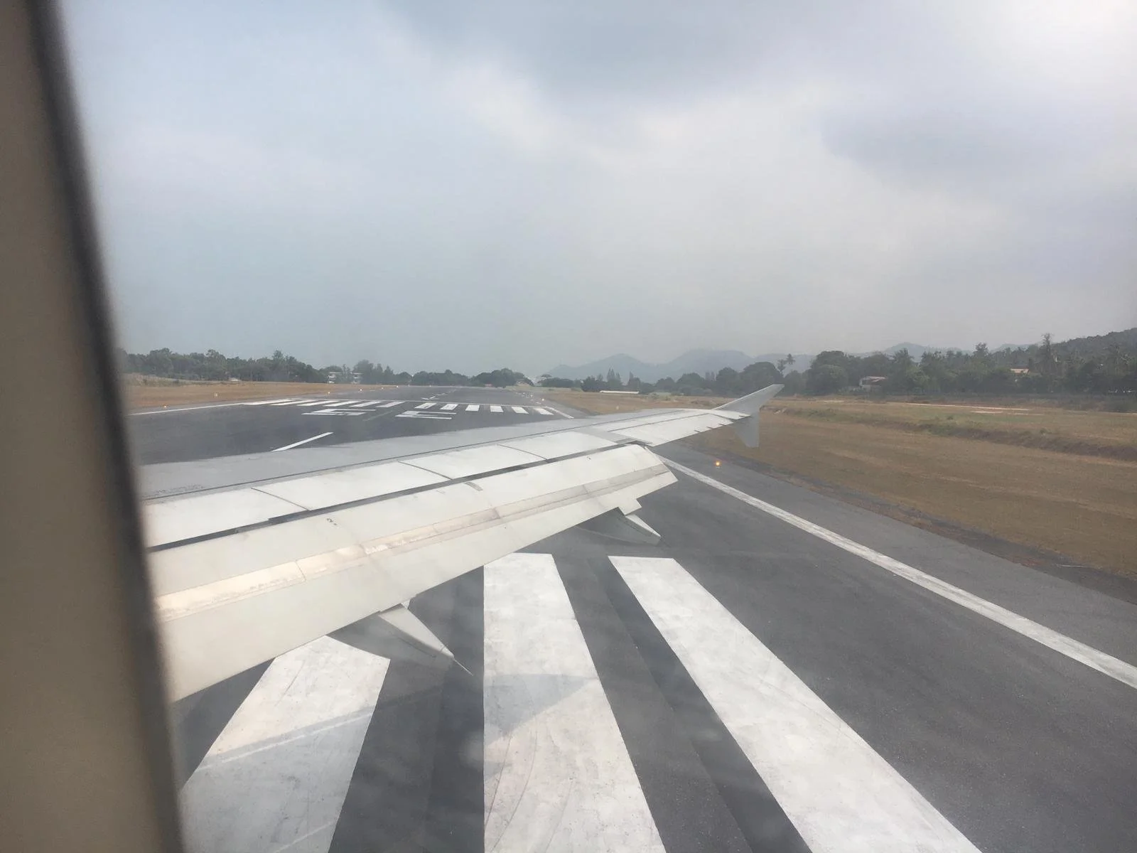 View from an airplane window onto a runway, symbolizing the journey towards clarity and answers, akin to exploring an FAQ page.